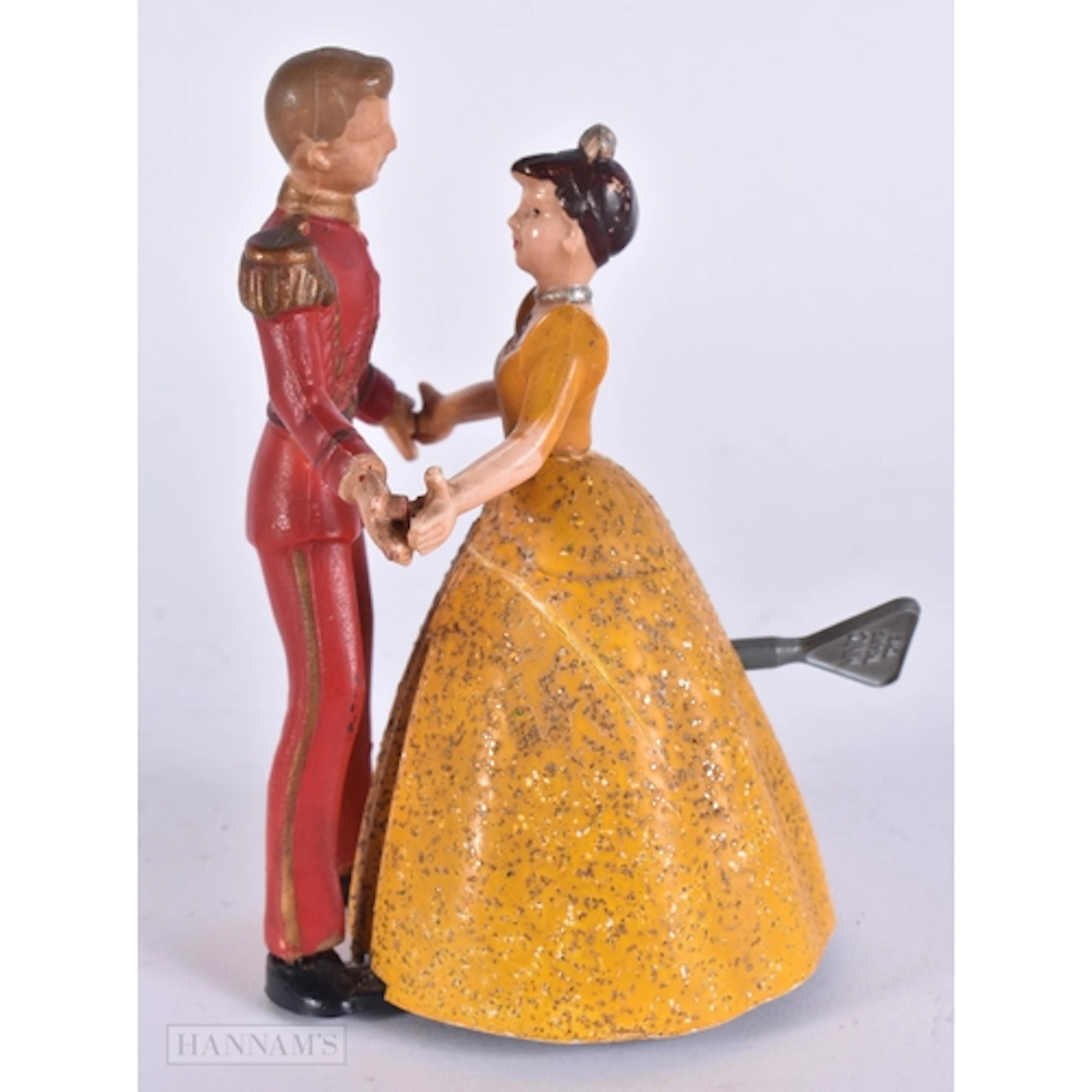 A VINTAGE MINIC WIND UP DANCING COUPLE. 13 cm high.