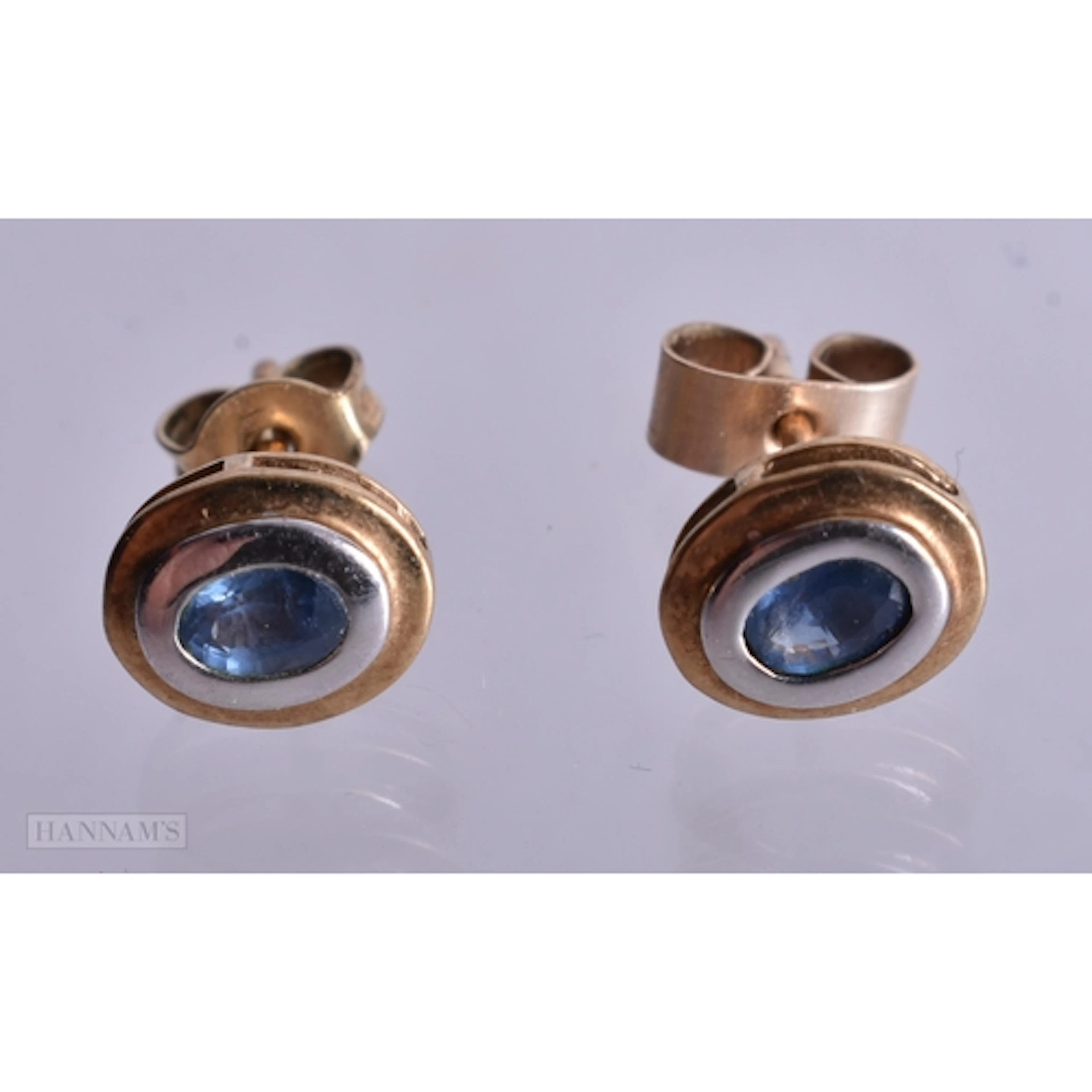 9ct gold sapphire bezel-set two-tone stud earrings (1.3g). 0...