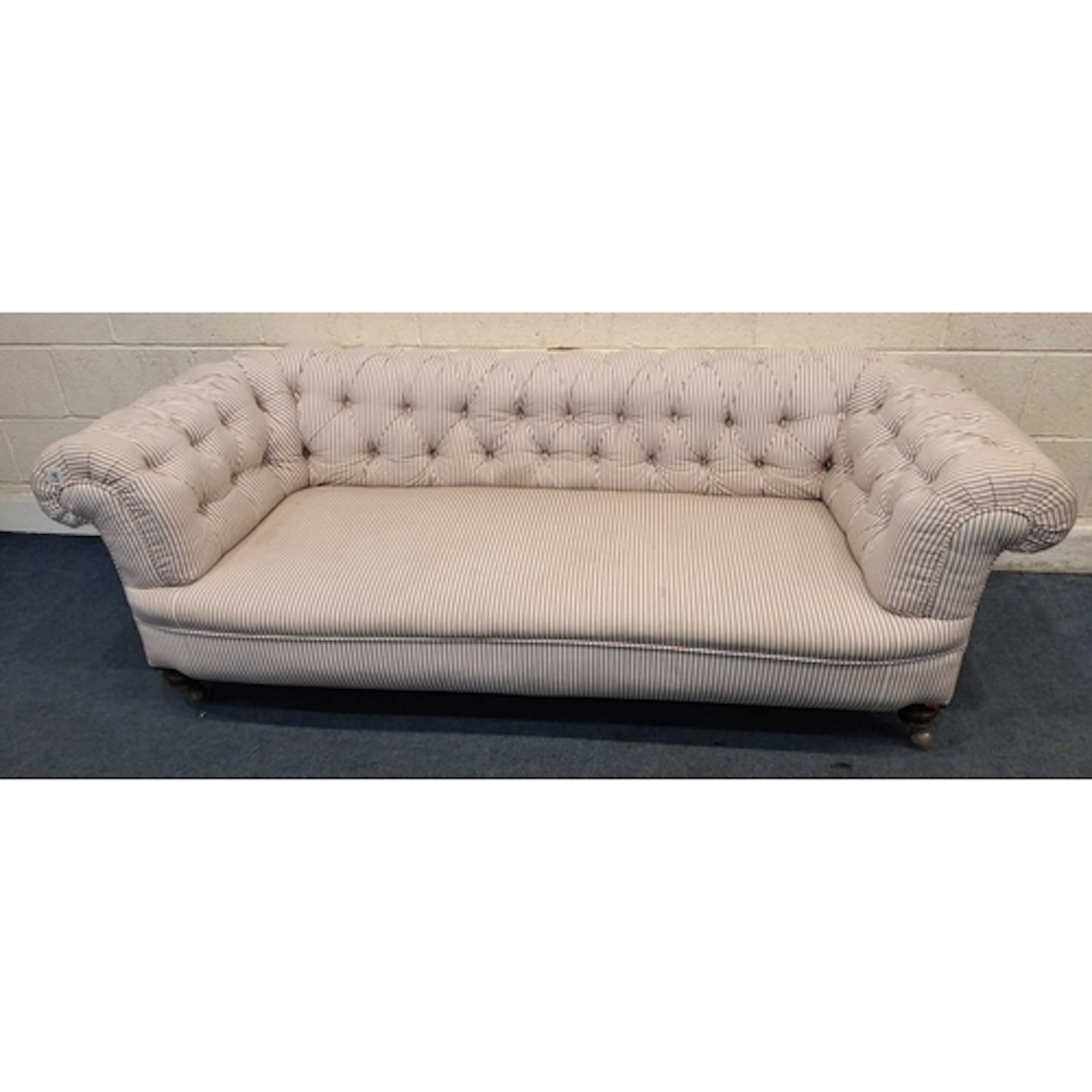 A STRIPED CHESTERFIELD STYLE SOFA, raised on later orbit cas...