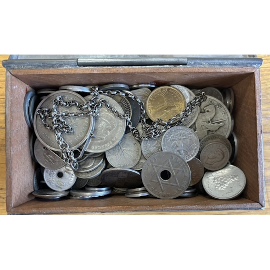 Collection of loose coins with some in treasure chest, gener...
