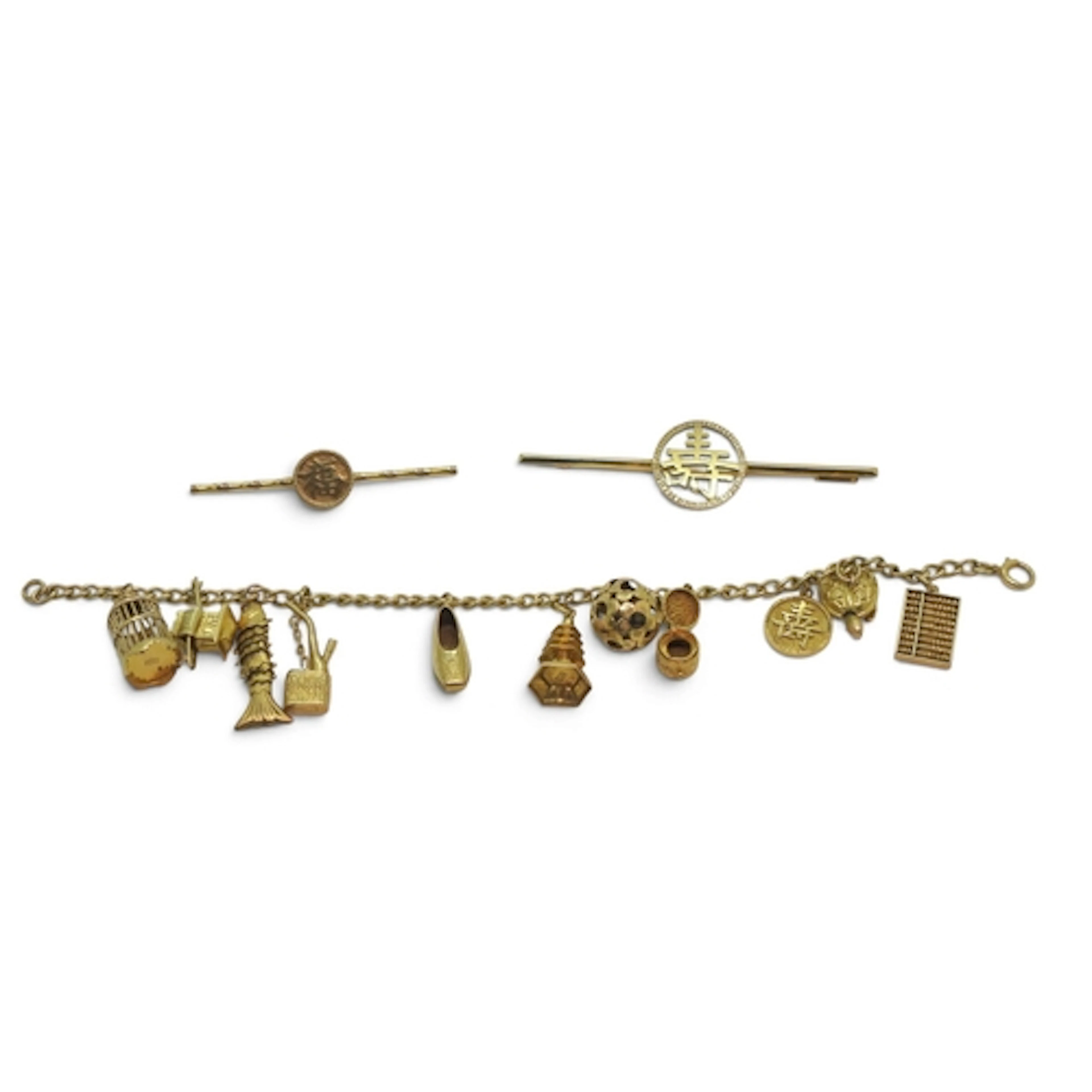 A 14k gold charm bracelet with eleven oriental style charms ...