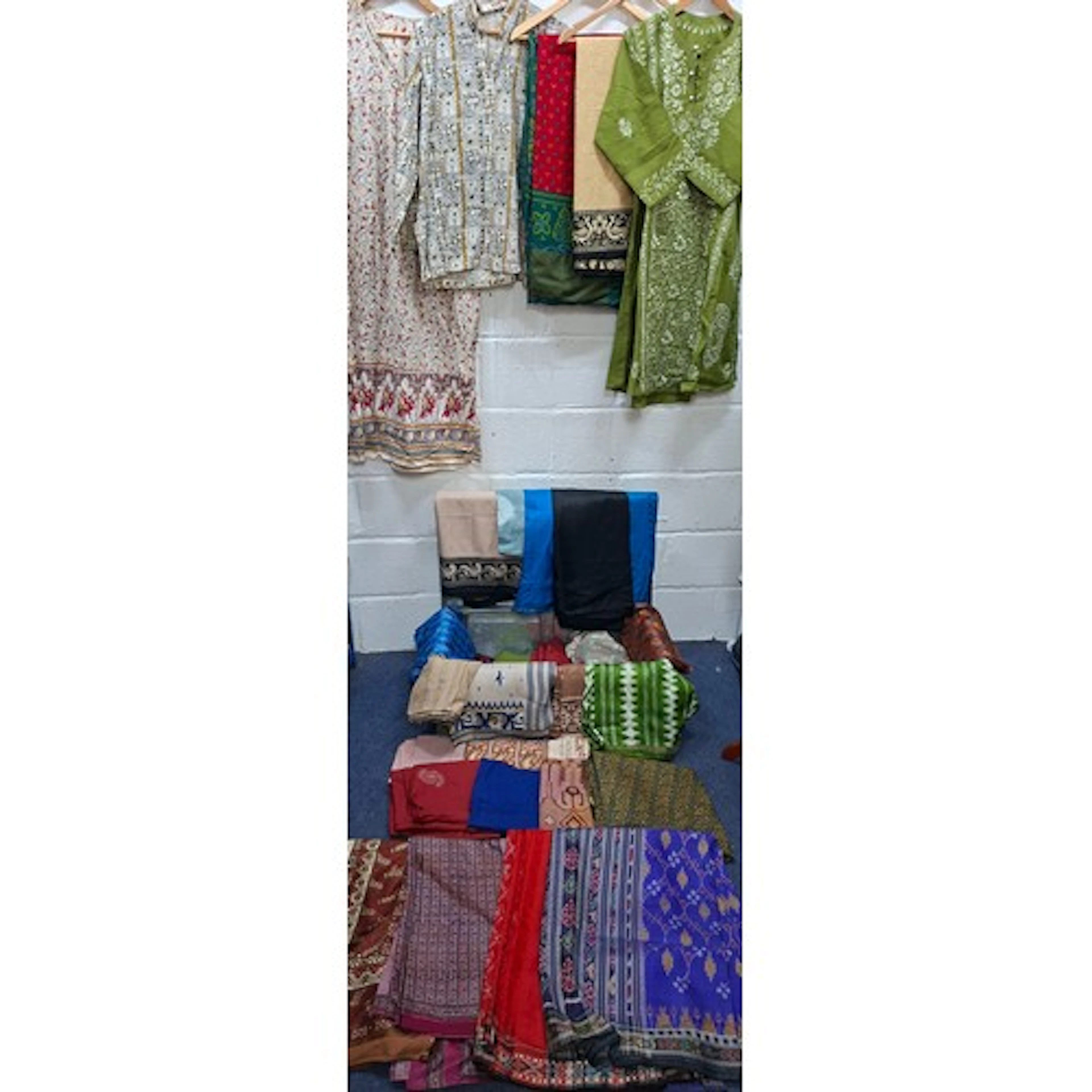 A metal trunk containing vintage Eastern fabric remnants, sa...