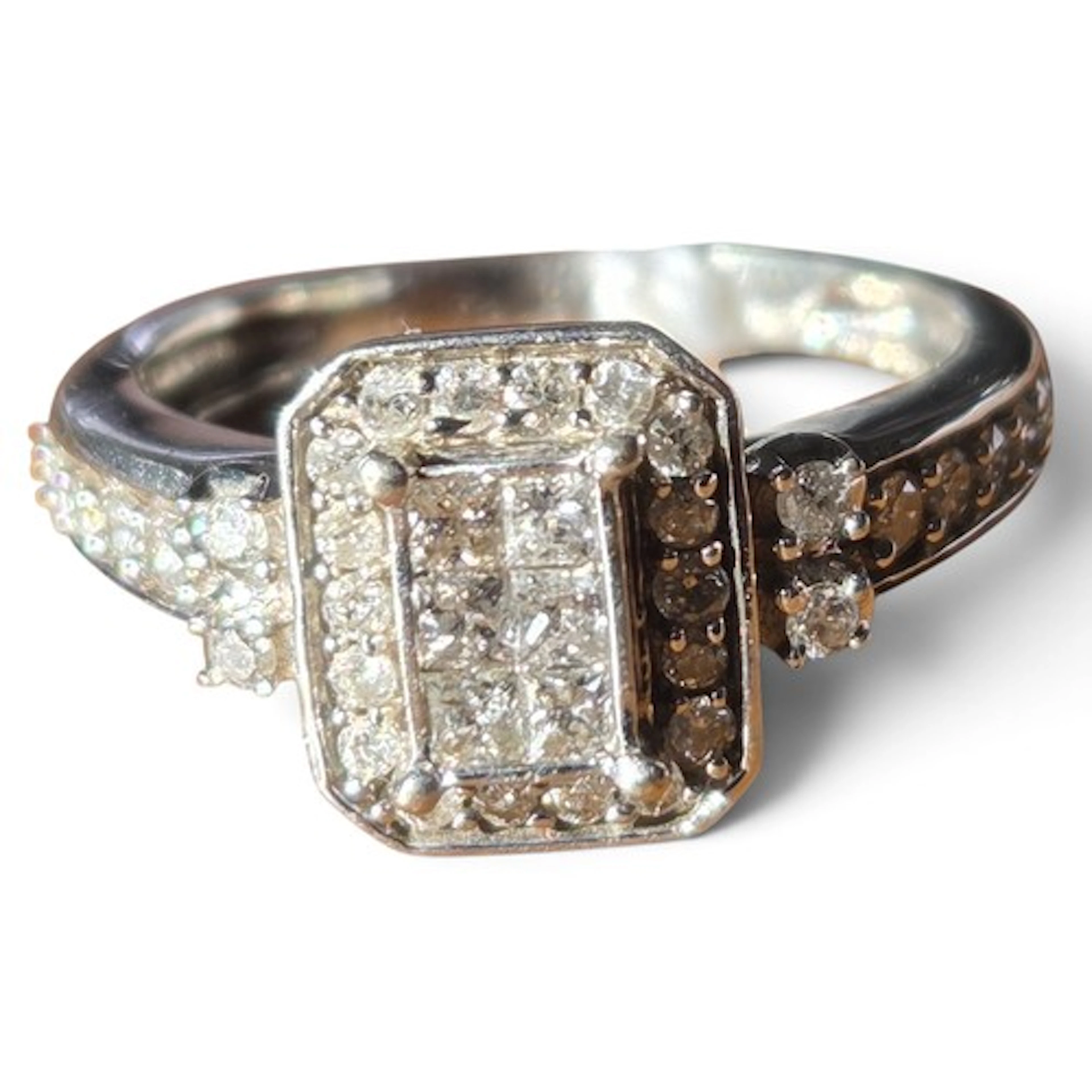 A diamond cluster ring set in 9 carat white gold, the raised...