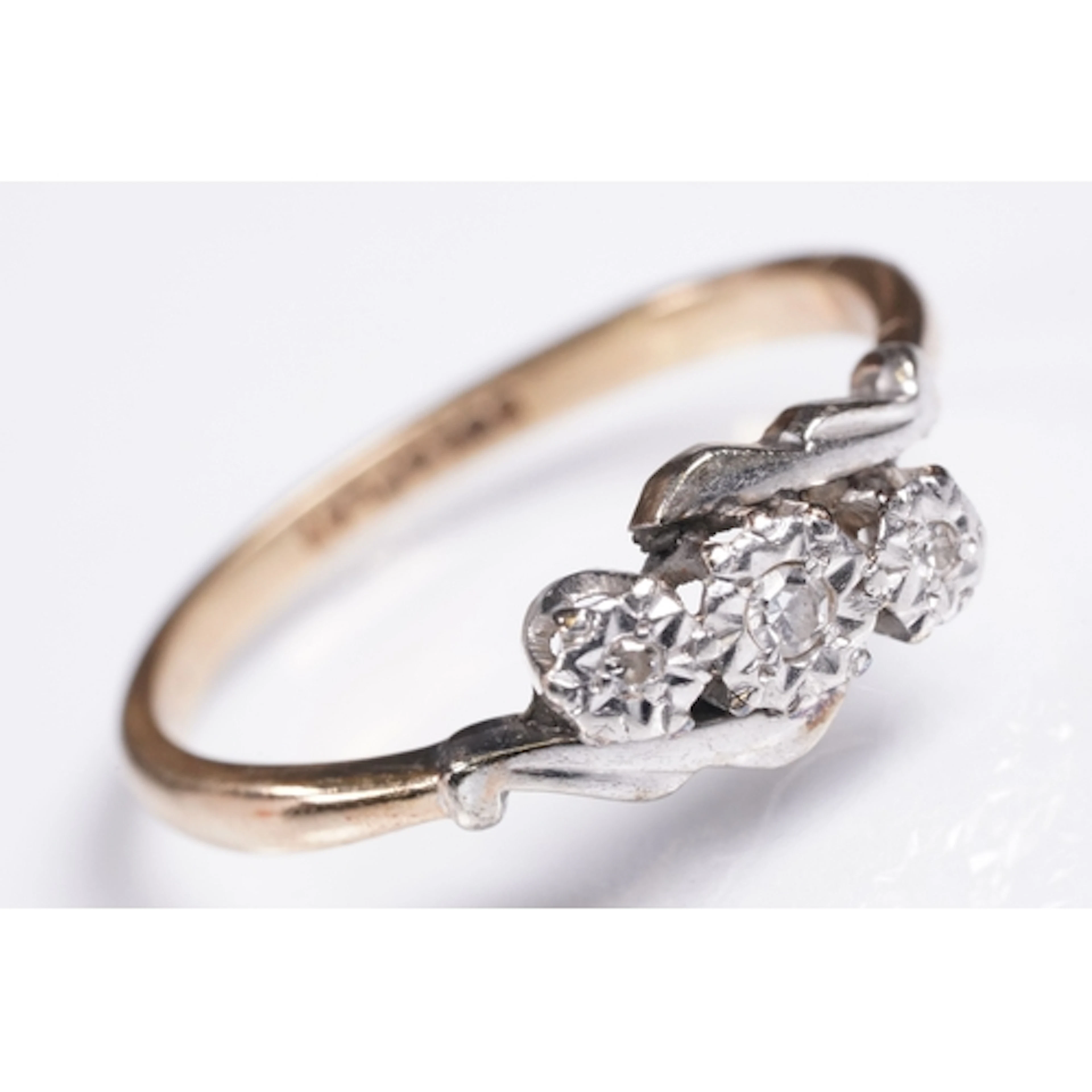 9ct gold and diamond three stone cross over ring. Marked 9ct...