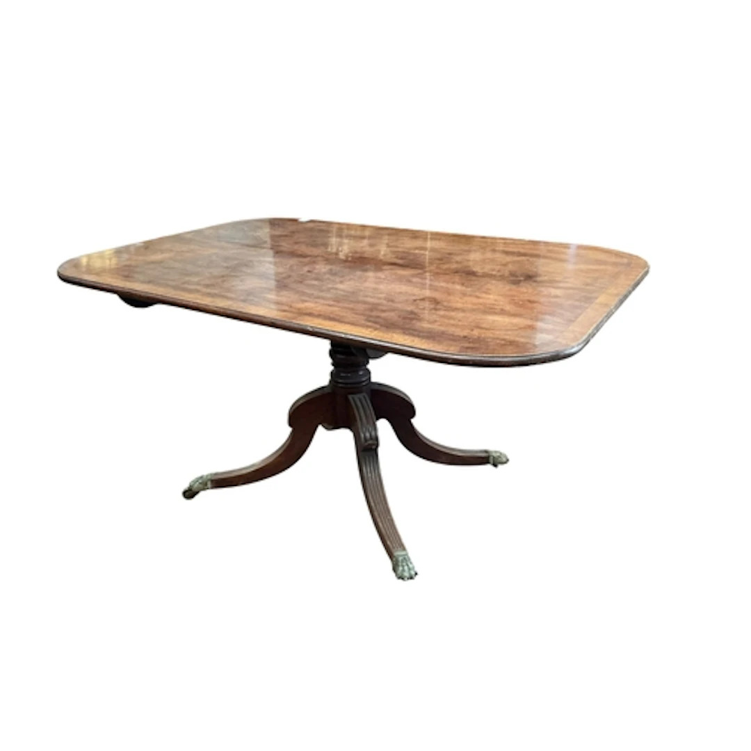A Regency crossbanded mahogany tilt top dining table, on a q...