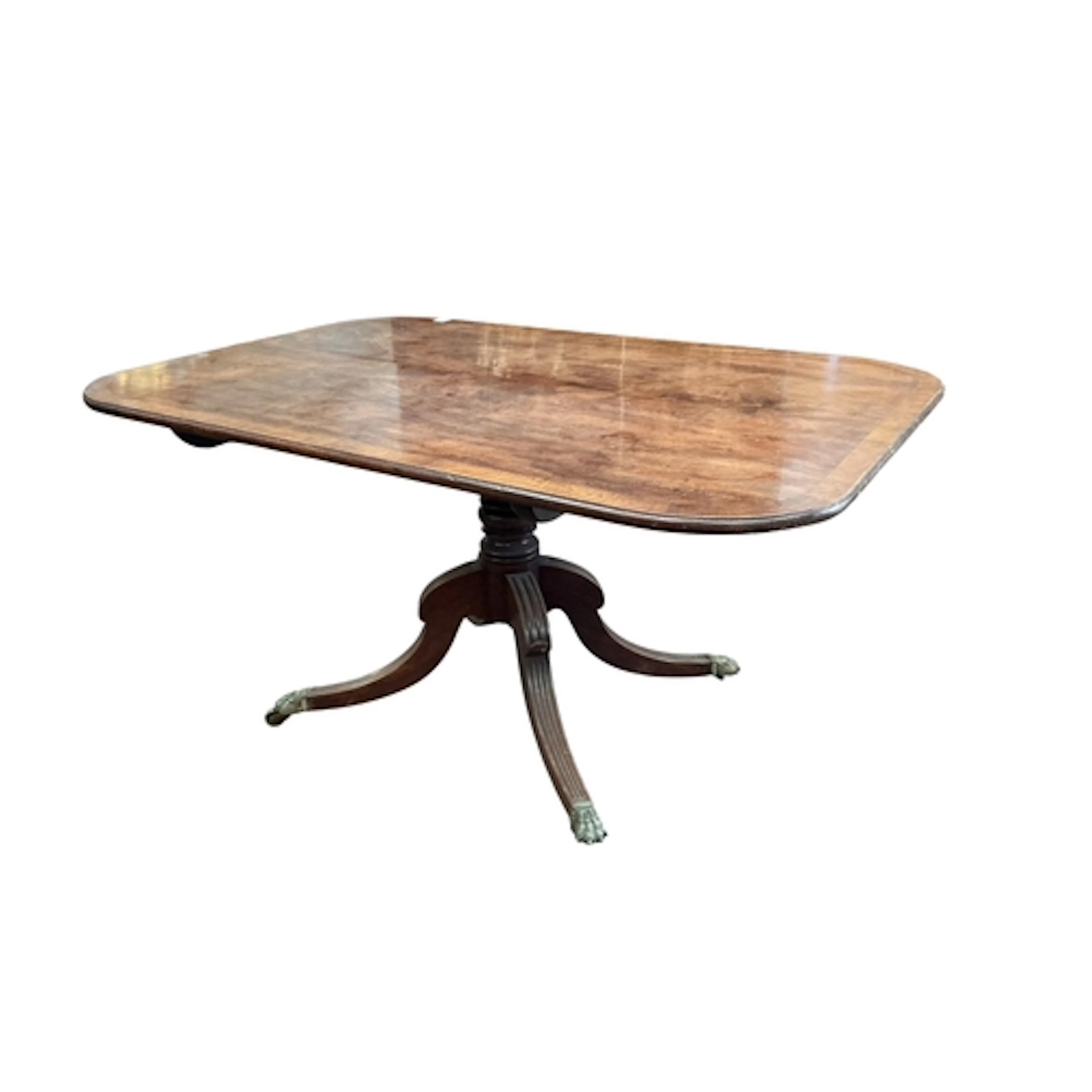 A Regency crossbanded mahogany tilt top dining table, on a q...