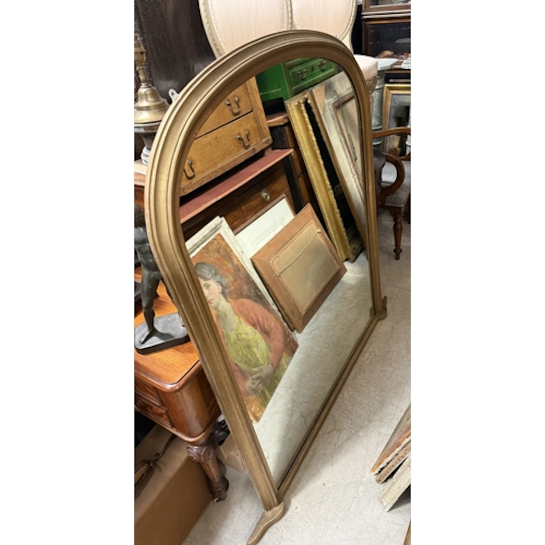 A GILDED OVERMANTLE WALL MIRROR
