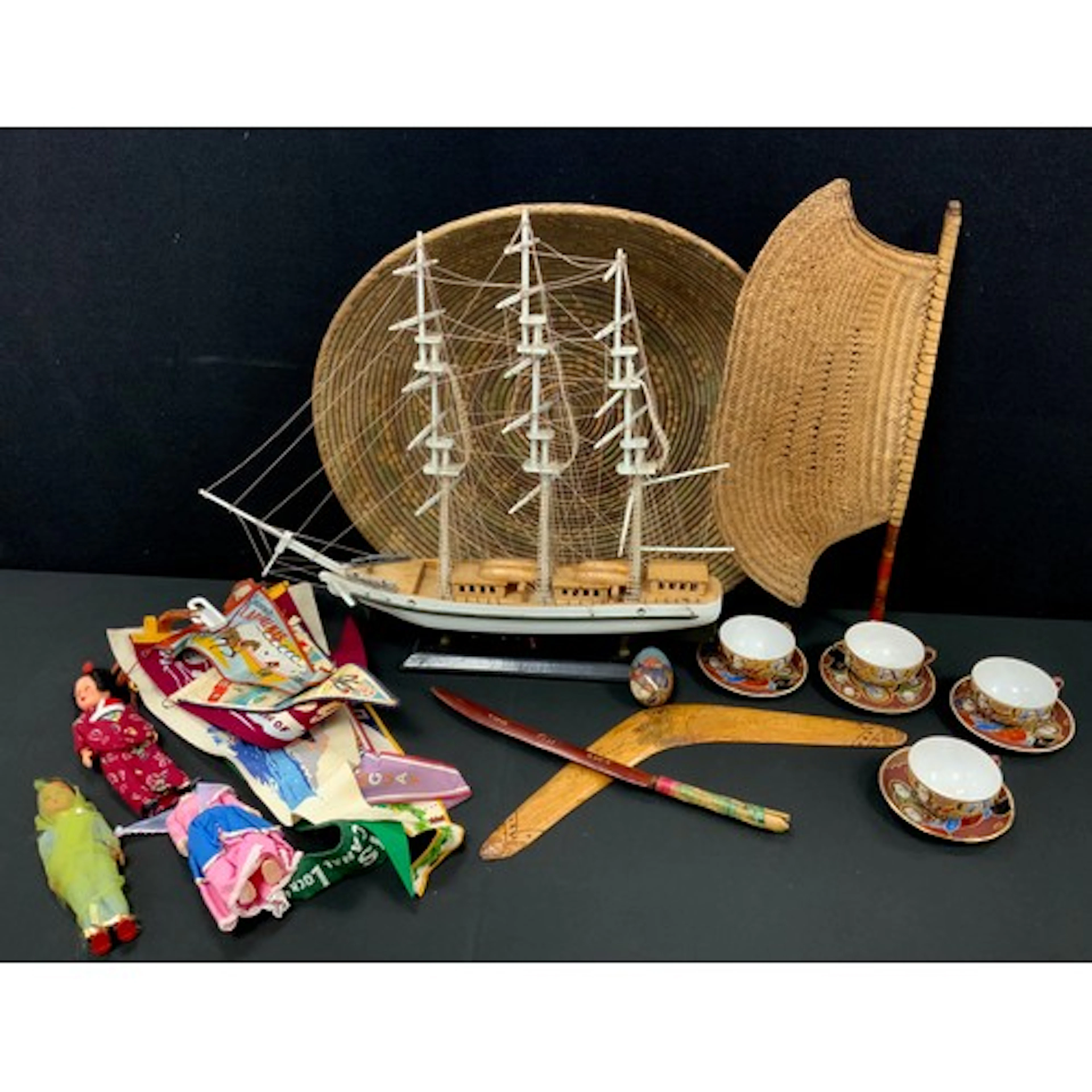 A boomerang , Fiji wooden knife, travel pennant flags, straw...
