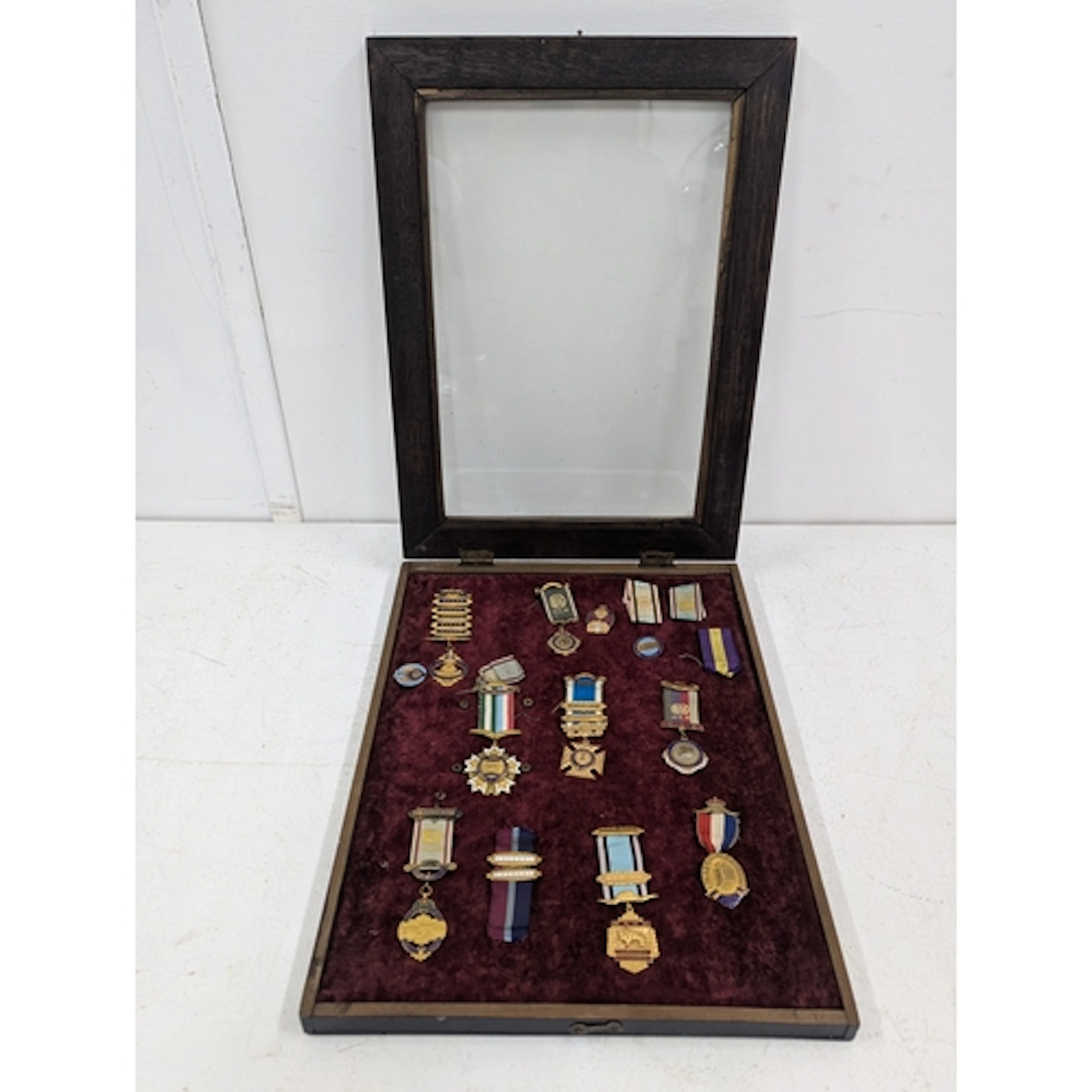 A group of Buffalo medals with ribbons, housed with a wooden...