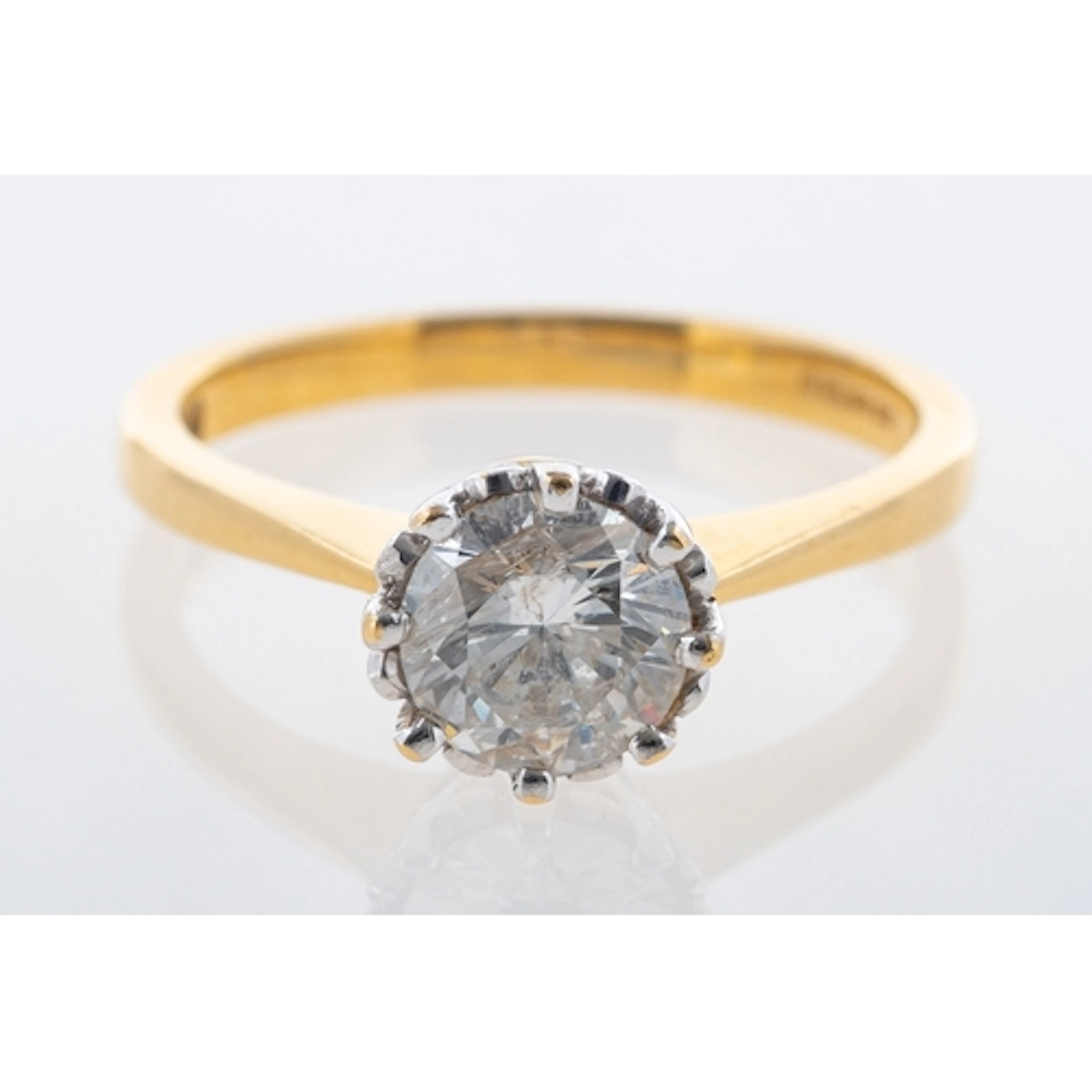 An 18ct gold diamond solitaire ring, the round brilliant cut...