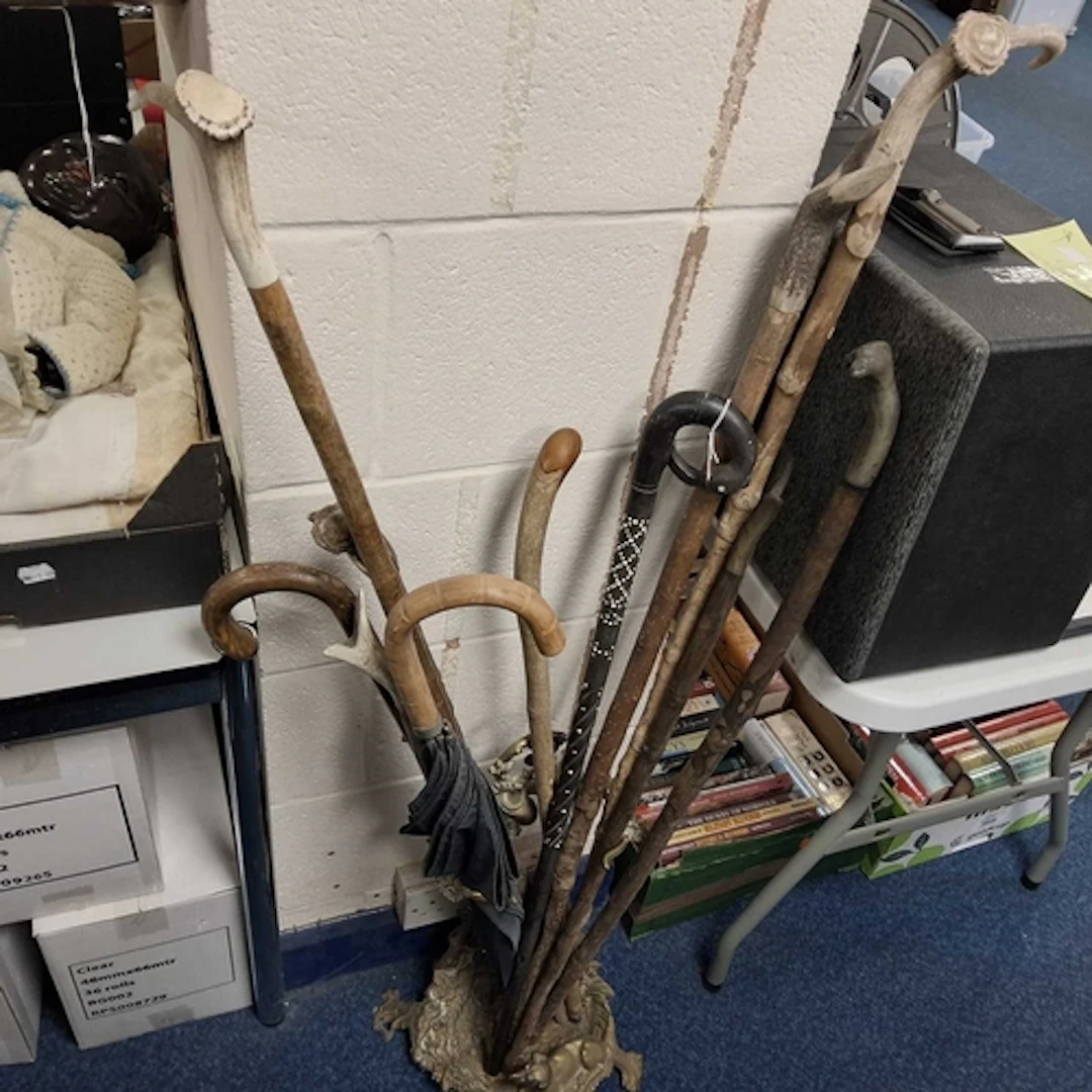 A GROUP OF WALKING STICKS AND BRASS STAND to include ten wal...