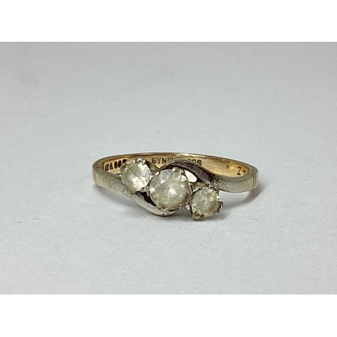 A Dainty Bi-Colour Three Stone Twist Ring, of graduated claw...