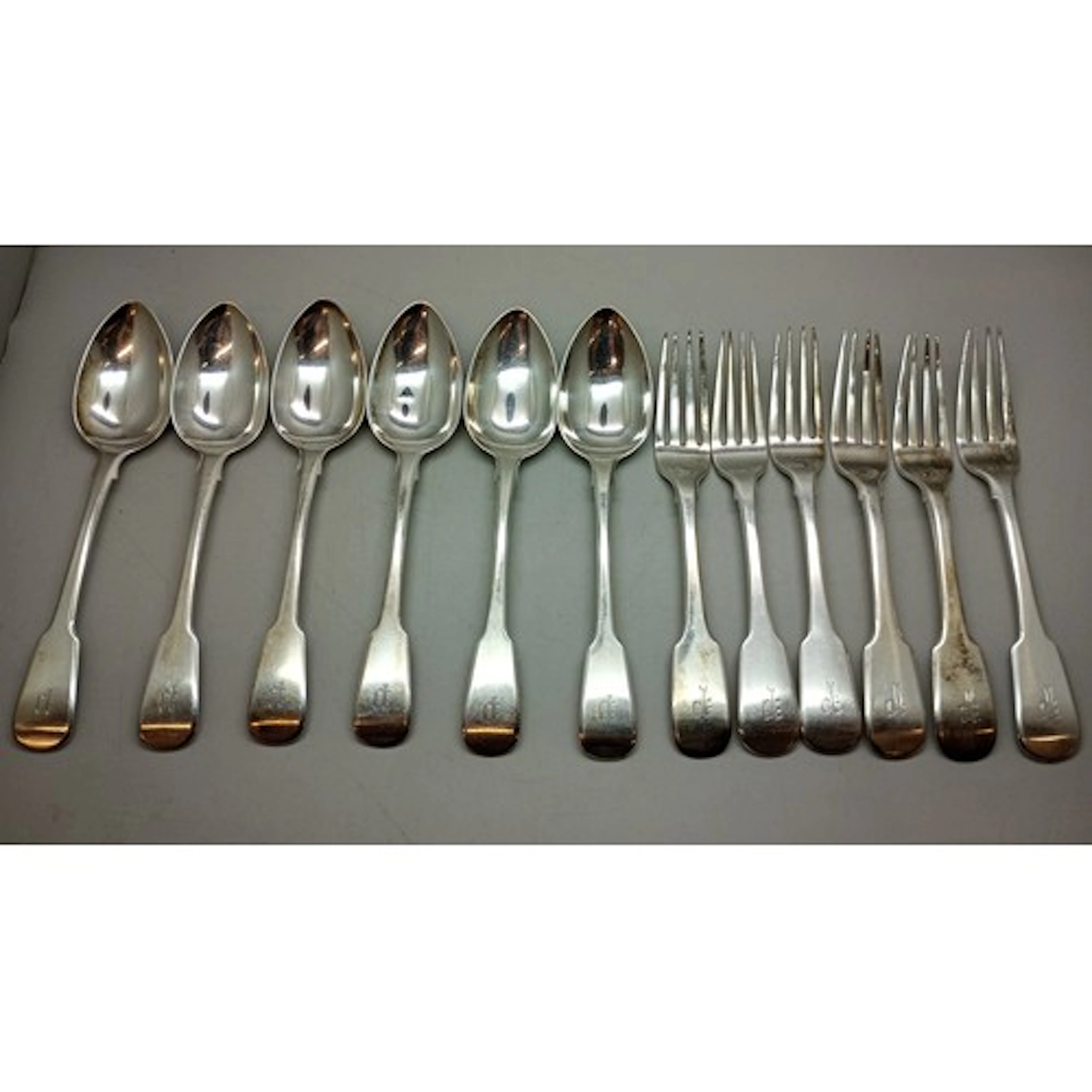 A George III 1820s silver cutlery set with monograms, all th...