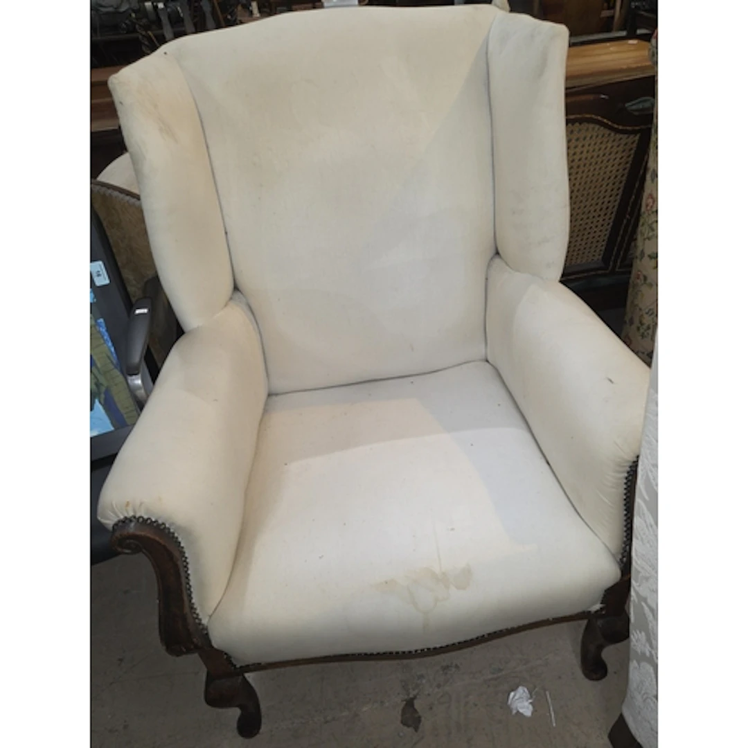 A late 19th/early 20th century wing chair on oak frame with ...