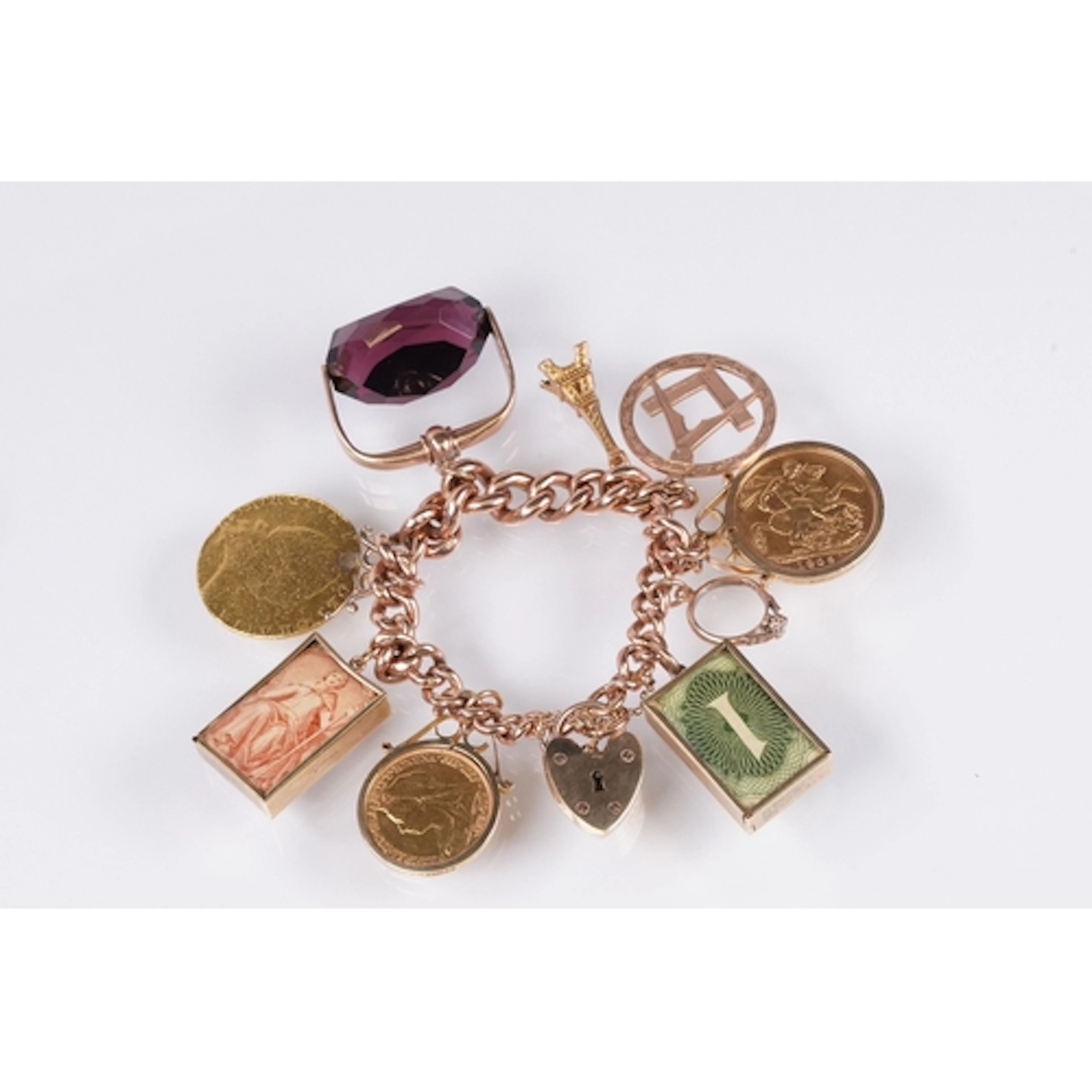9ct gold charm bracelet with nine charms including a 1909 fu...