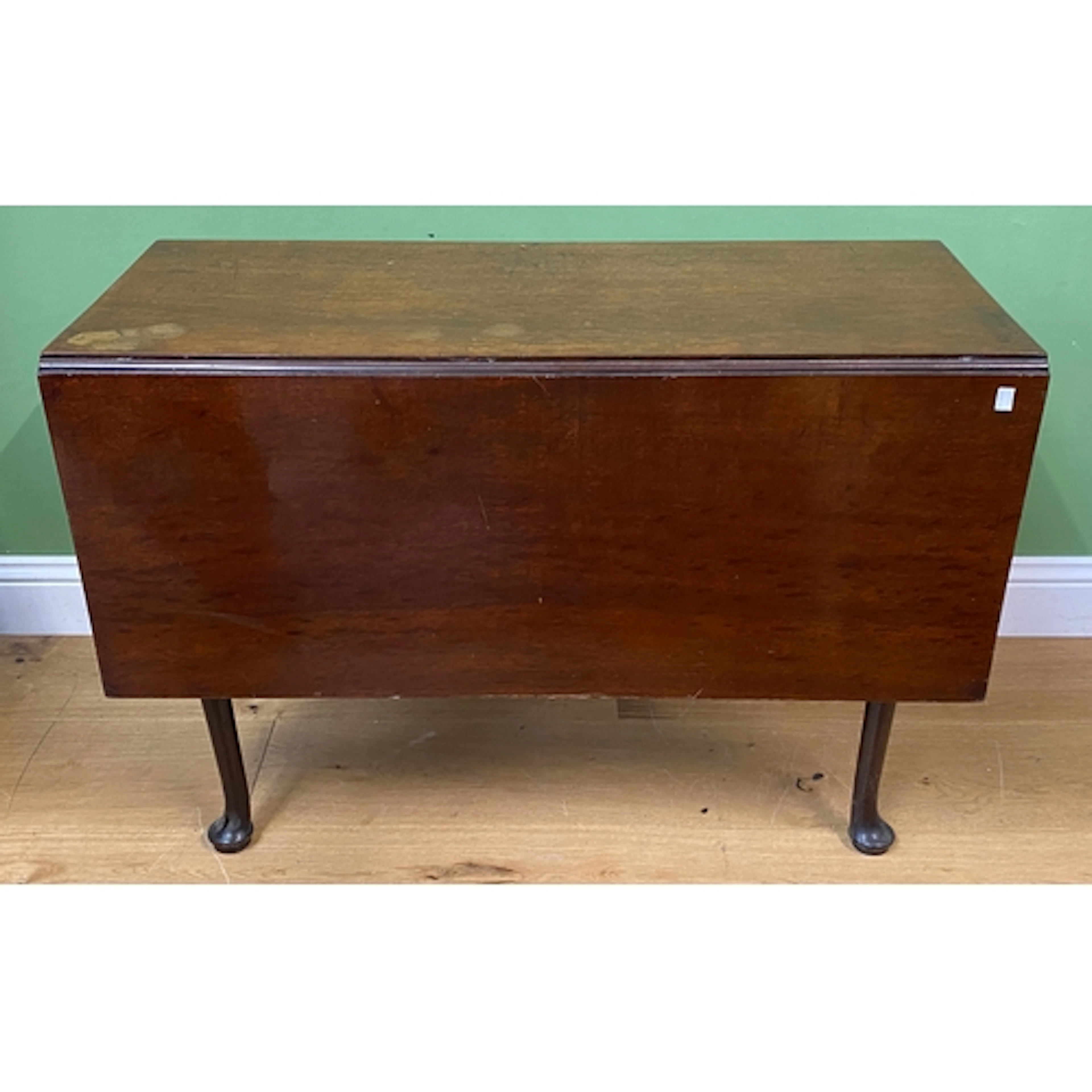 A George III rectangular mahogany gateleg table on turned ta...