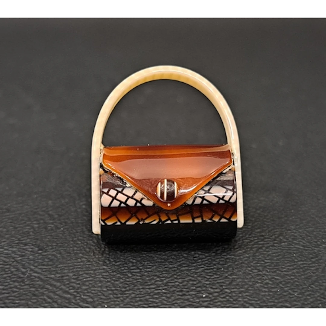 LEA STEIN HANDBAG BROOCH with lace effect finish to the brow...