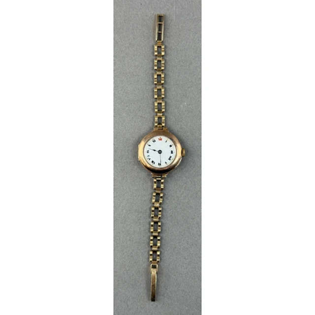 Watches: a 9ct yellow gold trench style wristwatch on open l...