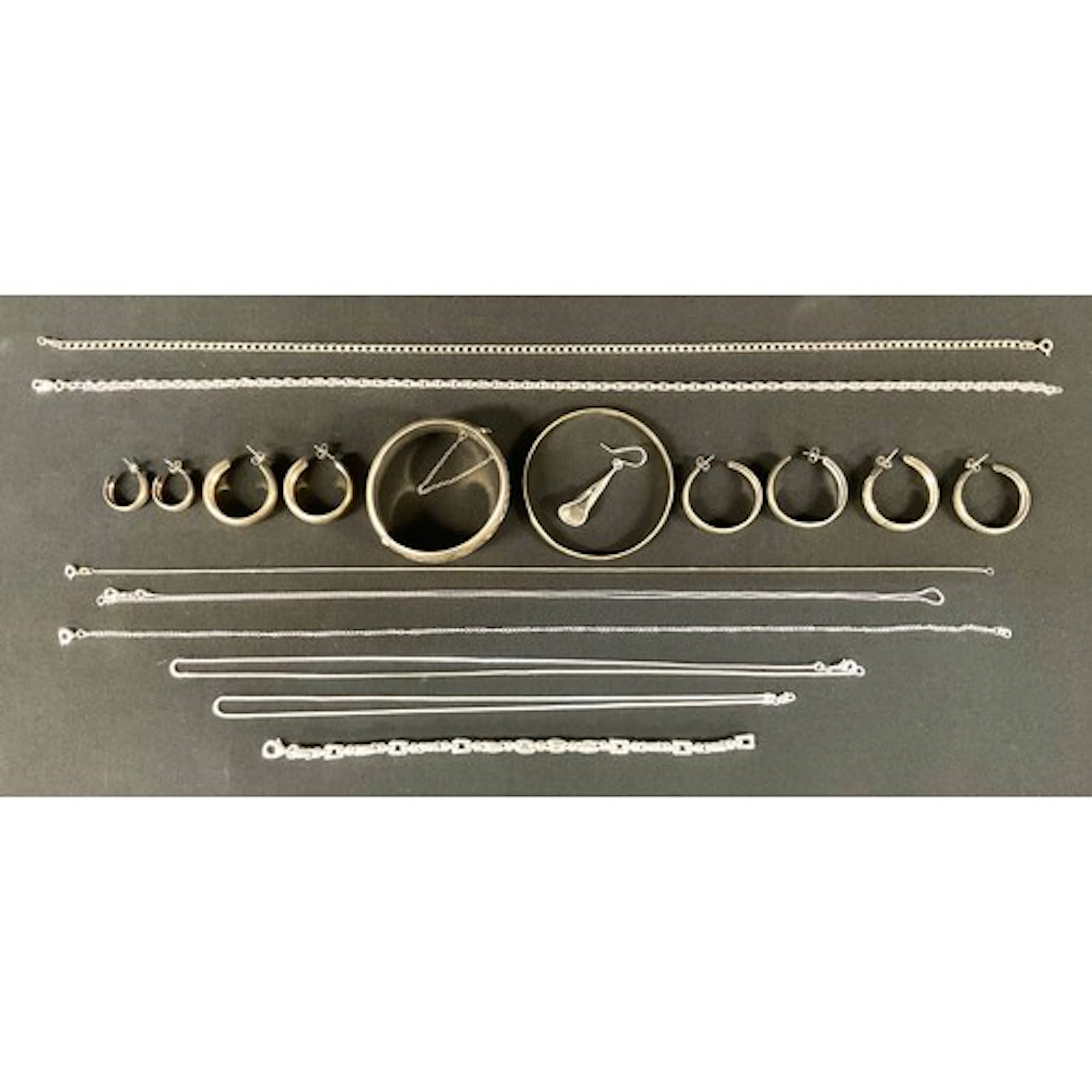 A silver hinge bangle, assorted silver chain necklaces, brac...