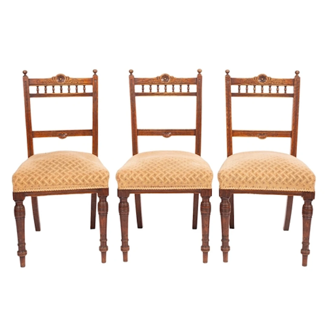 A set of three late Victorian oak and upholstered side chair...