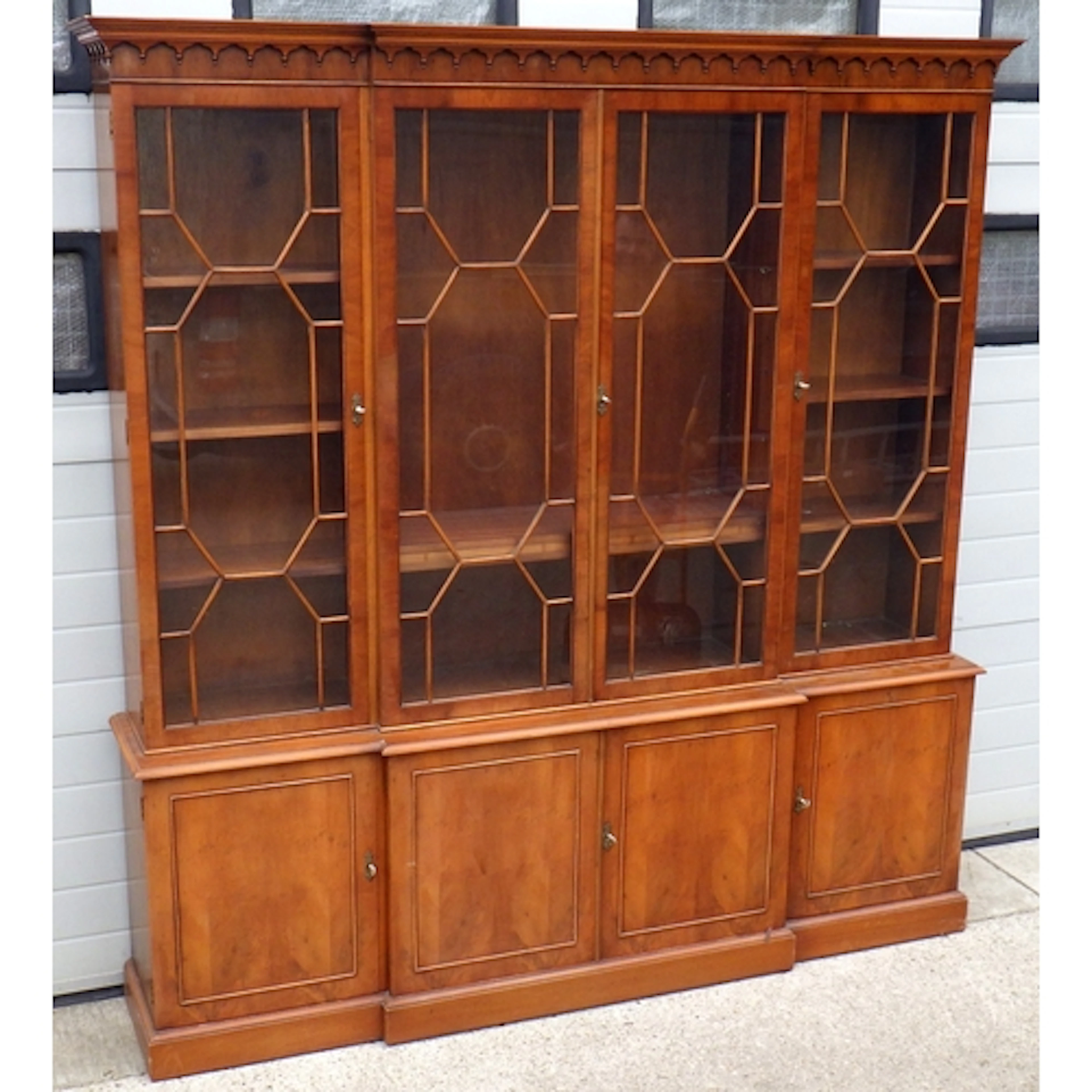 A reproduction yew four door, breakfront bookcase, faded, 20...