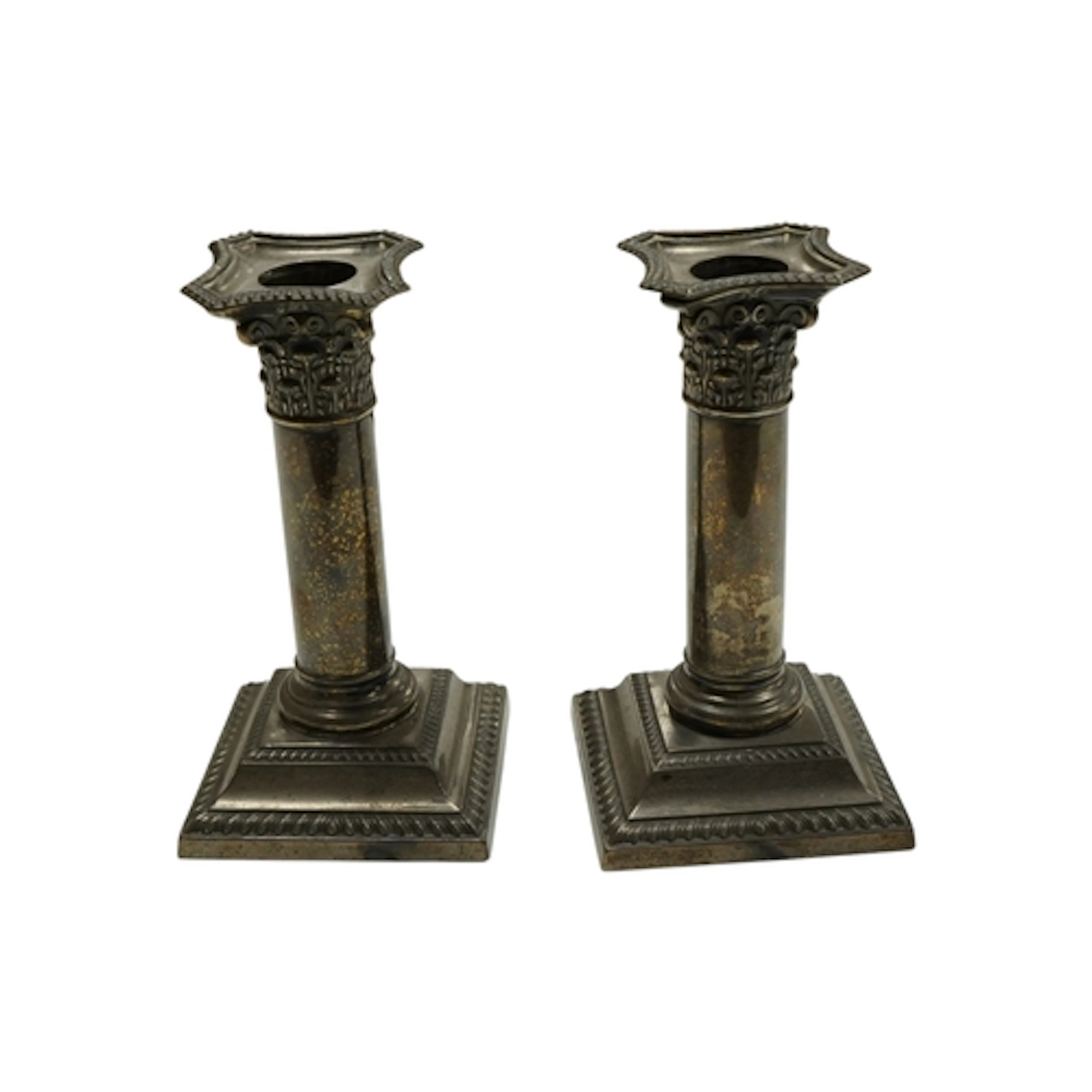 A pair of Edwardian silver dwarf corinthian column candlesti...