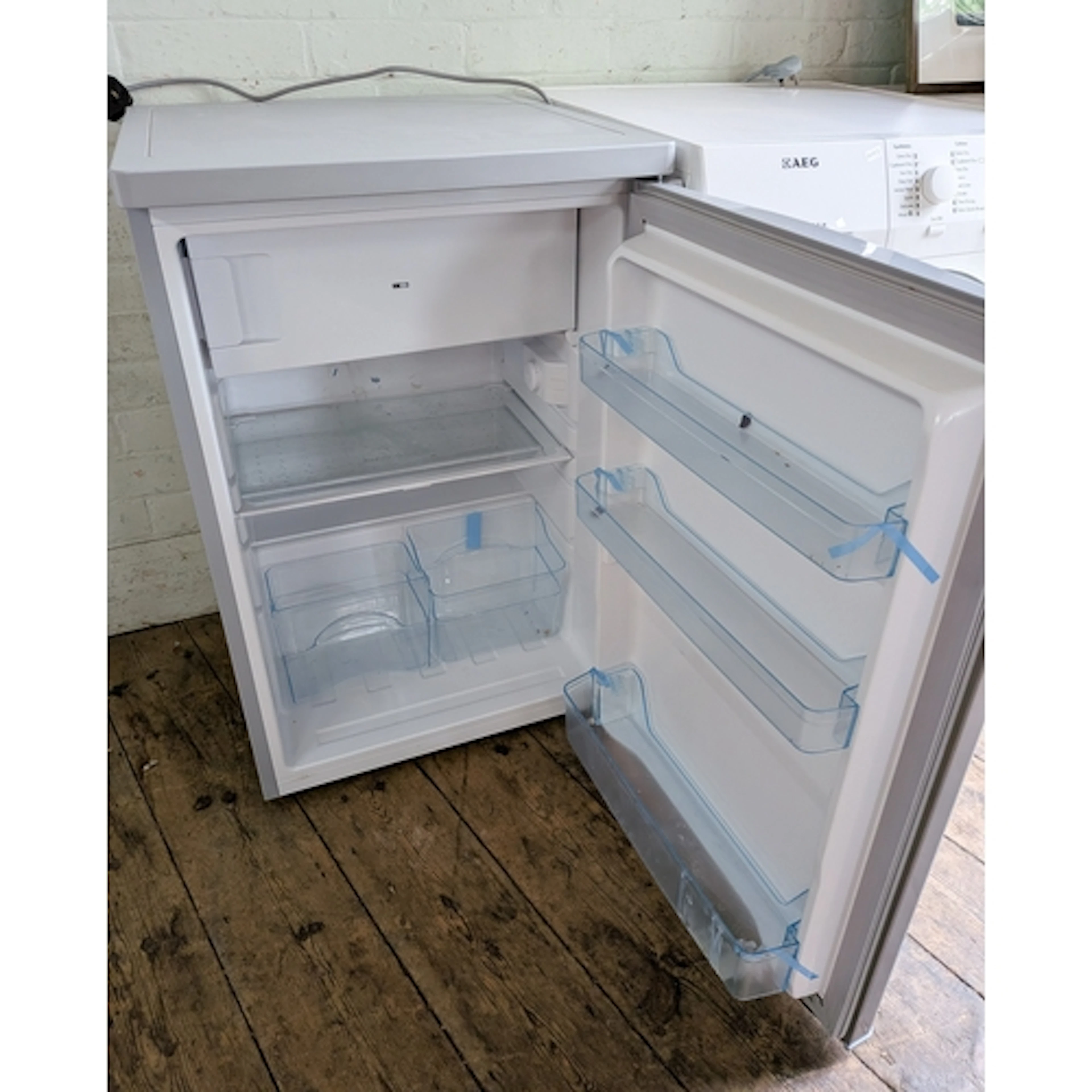 A silver cased Ice King worktop height fridge fitted shelves...