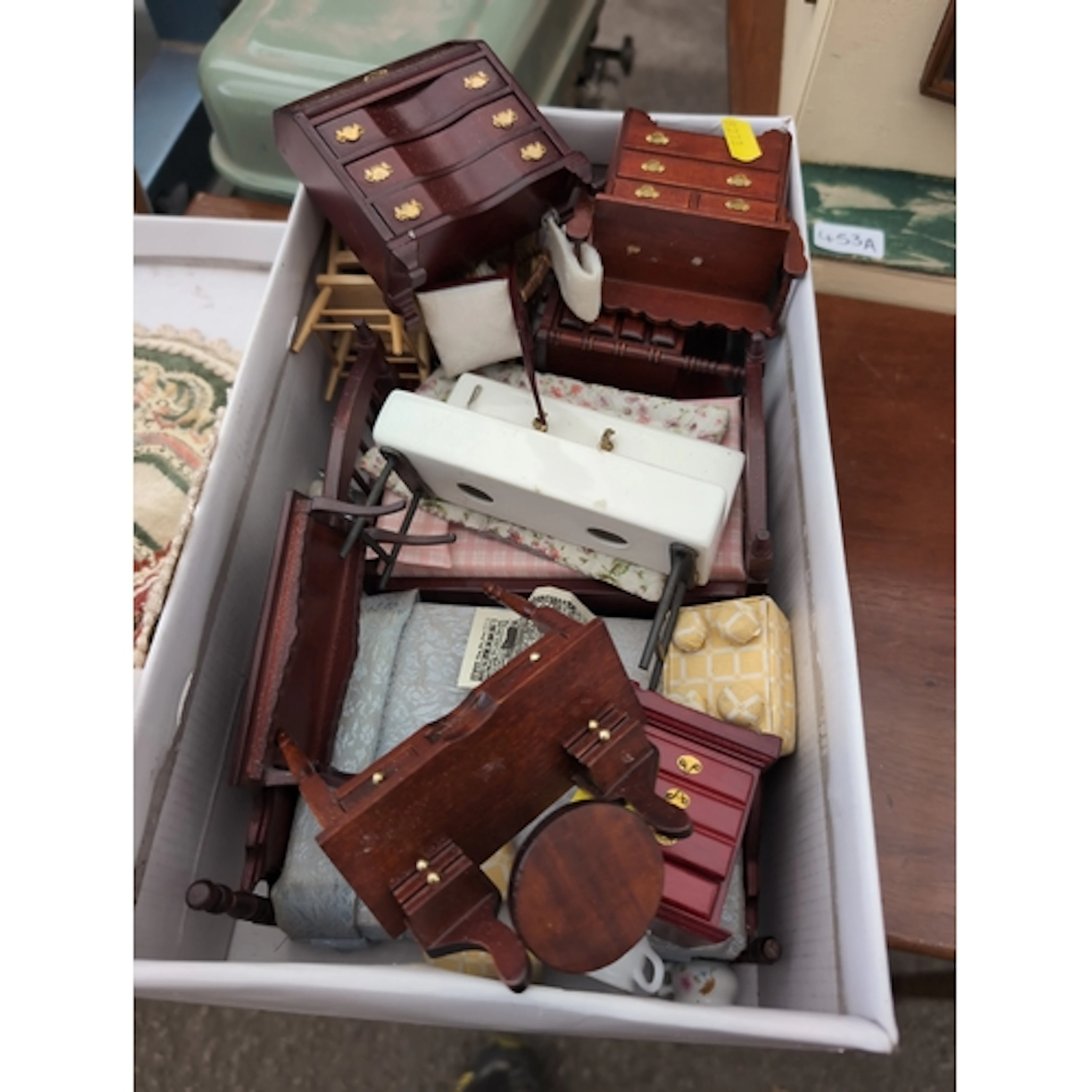 Quantity of dolls house furniture, mostly in an early c20 st...