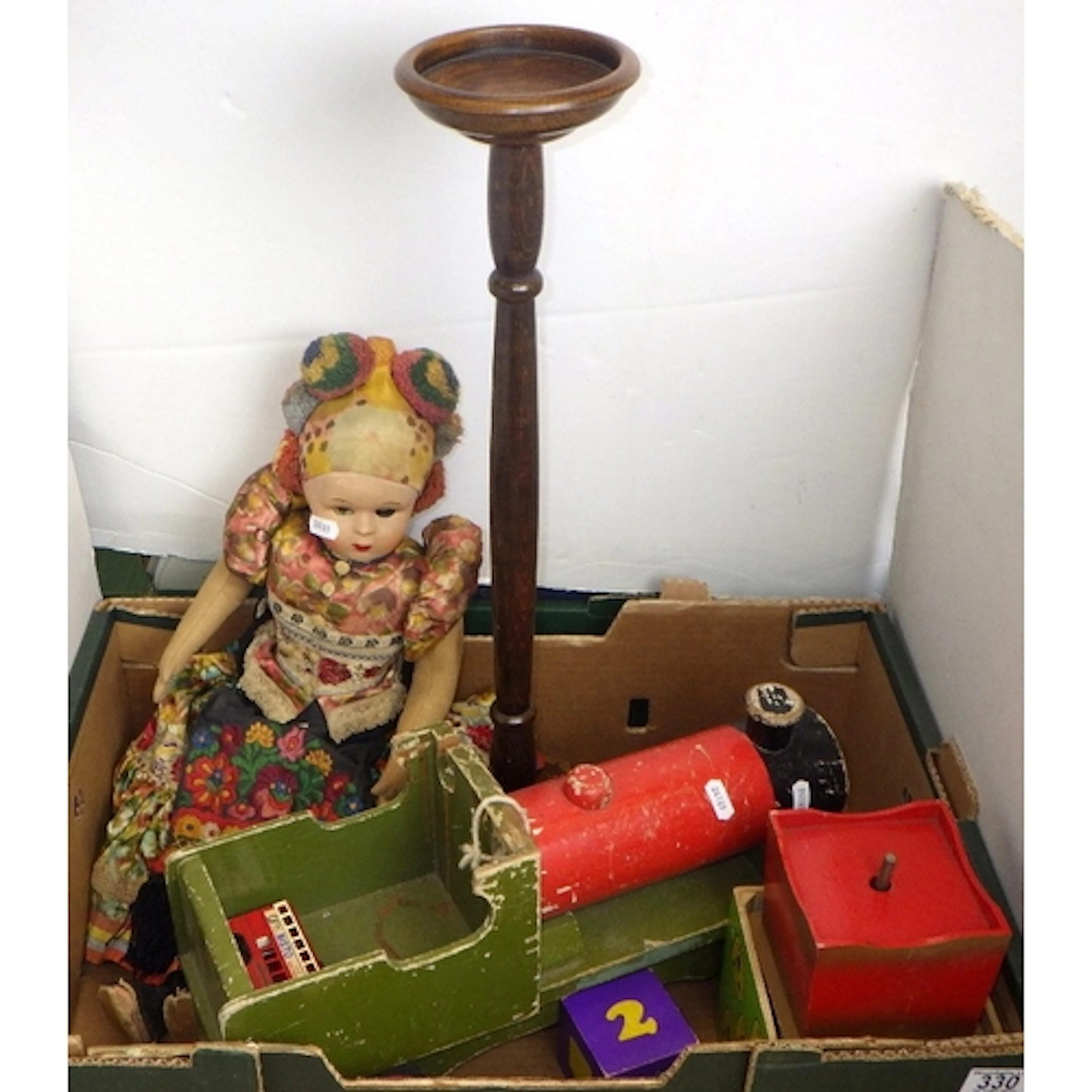 A vintage doll in needlework dress together with a wooden tr...