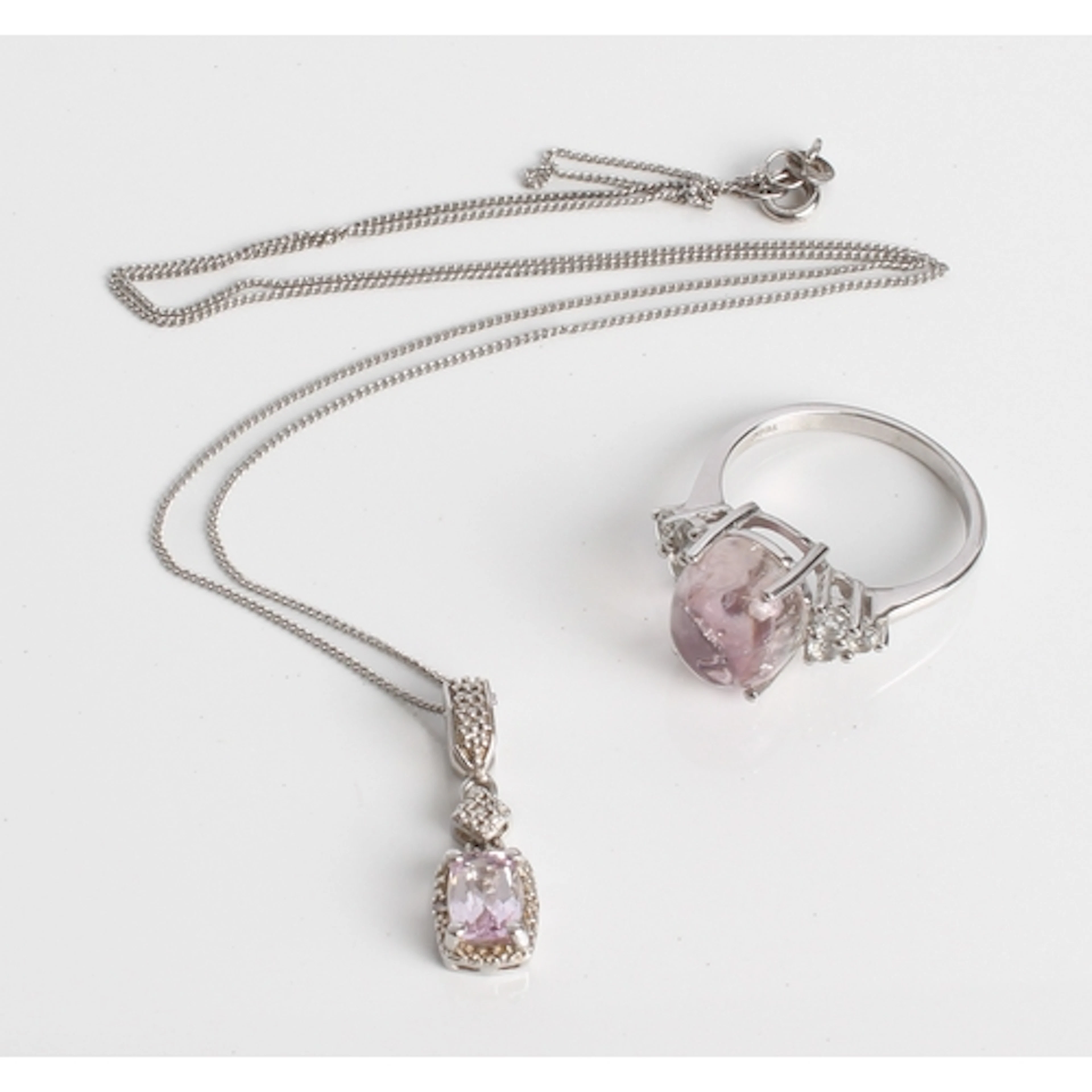 A sterling silver mawl kunzite and champagne diamond pendant...