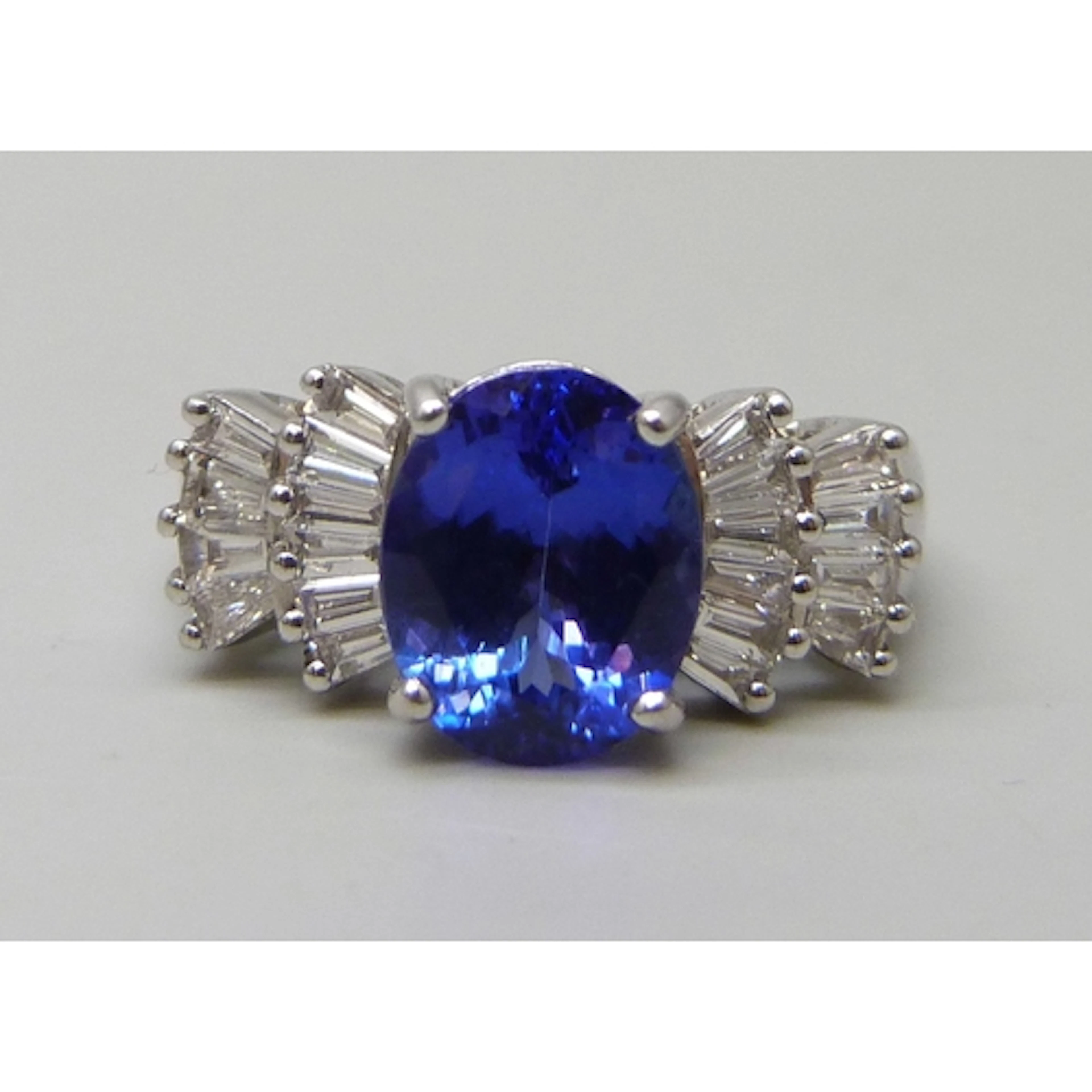 An 18ct white gold, possibly tanzanite, and diamond ring, 5....