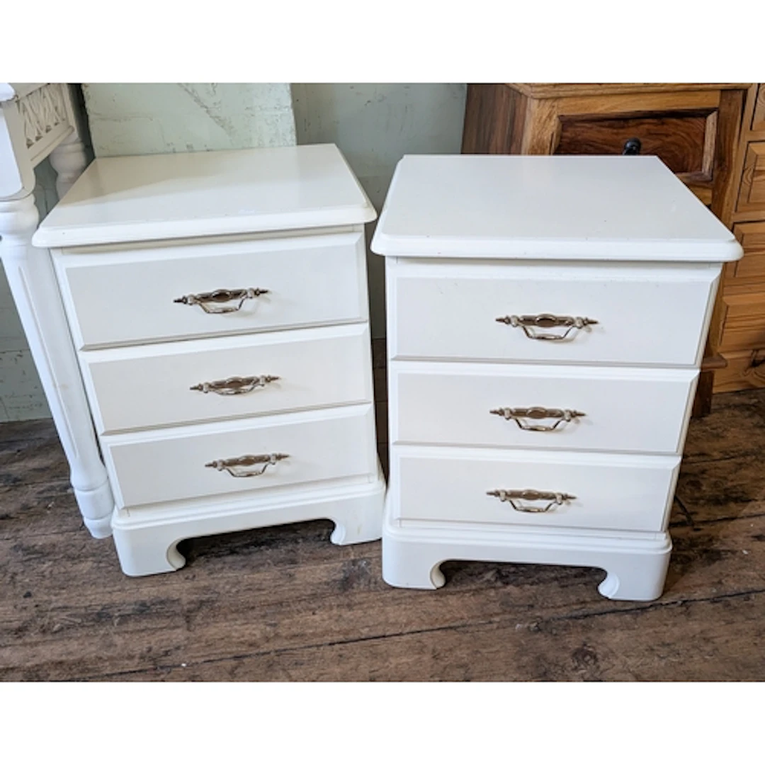A pair of modern three drawer white bedside chests