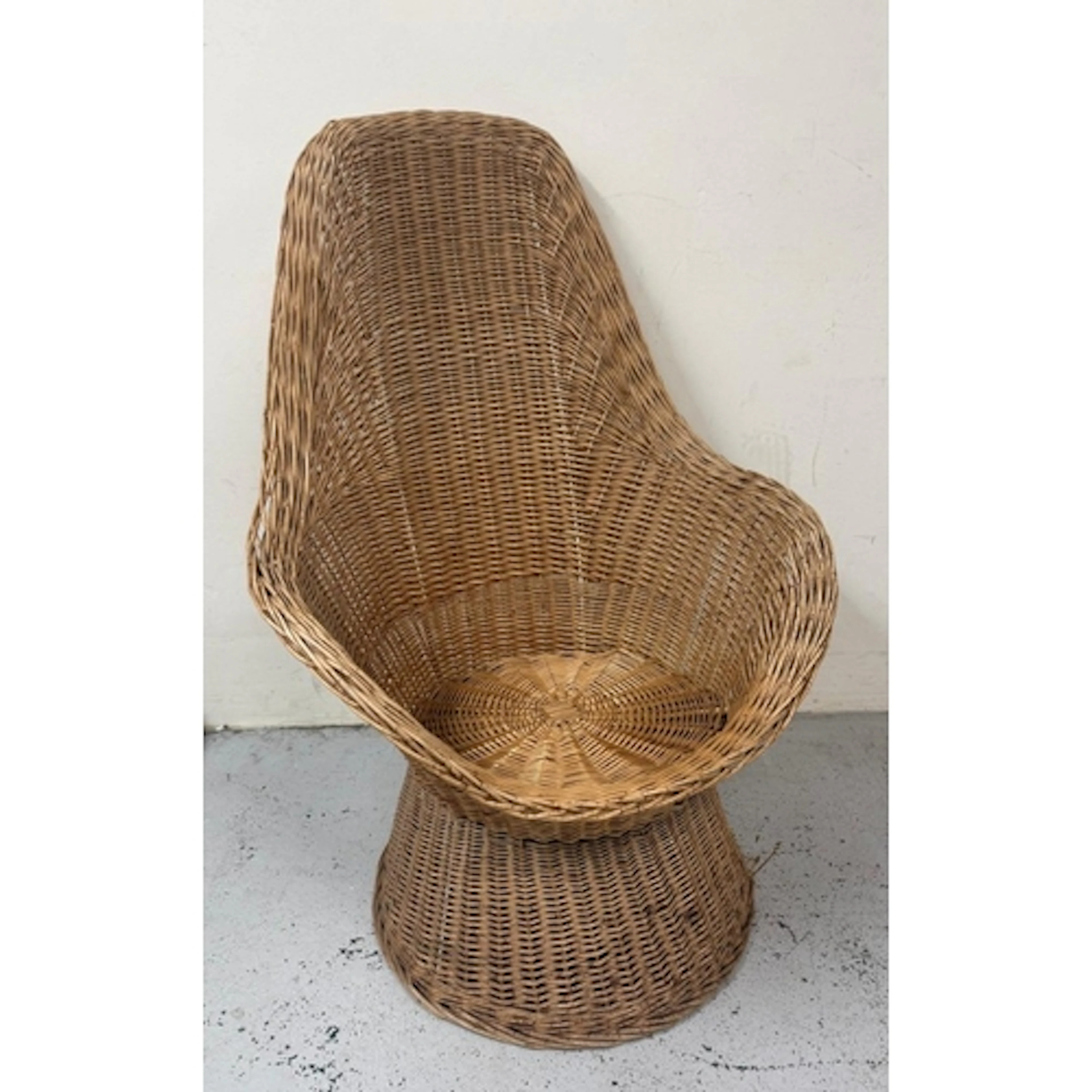 A mid-century high backed wicker lounge chair