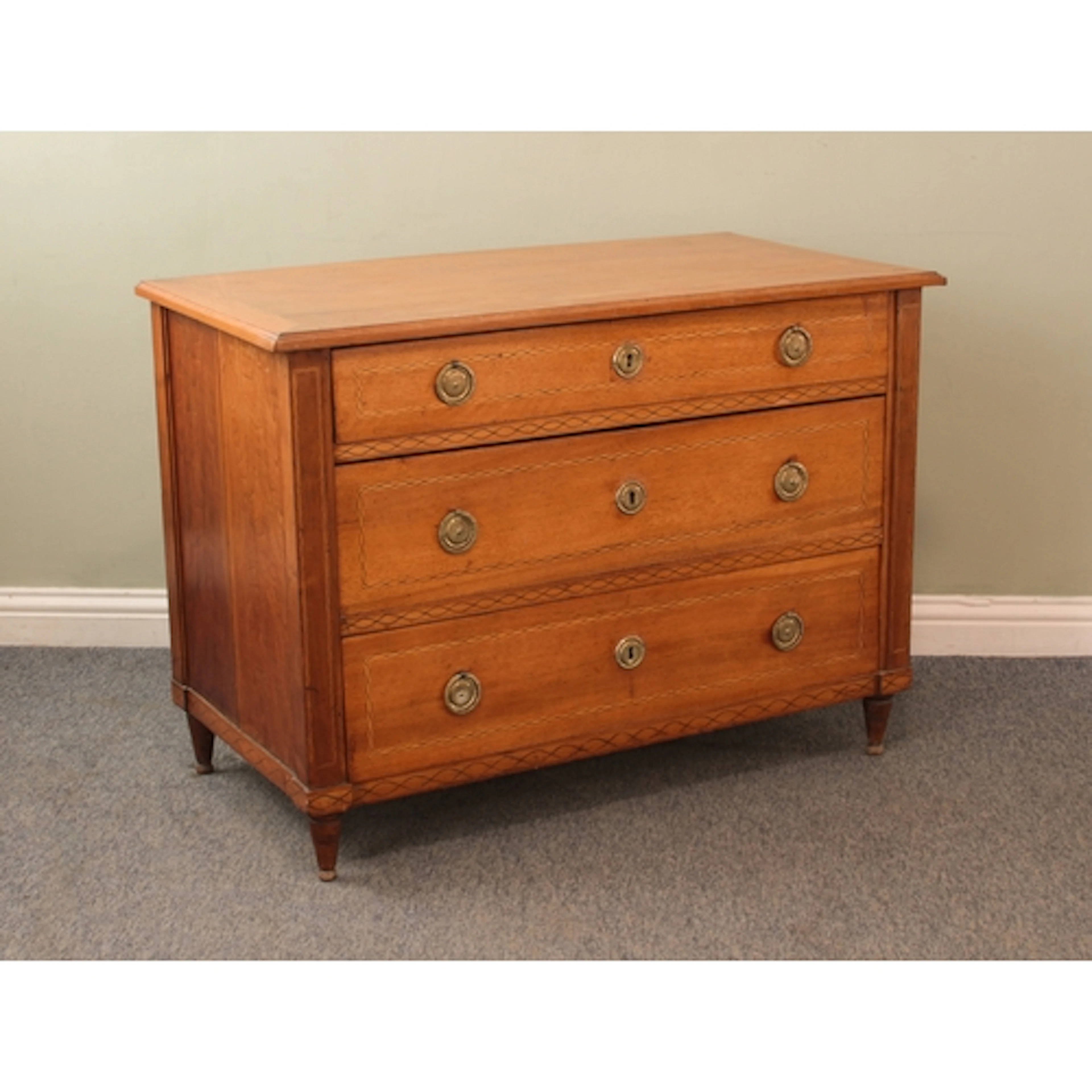 A 19th century French inlaid cherry wood commode or chest of...