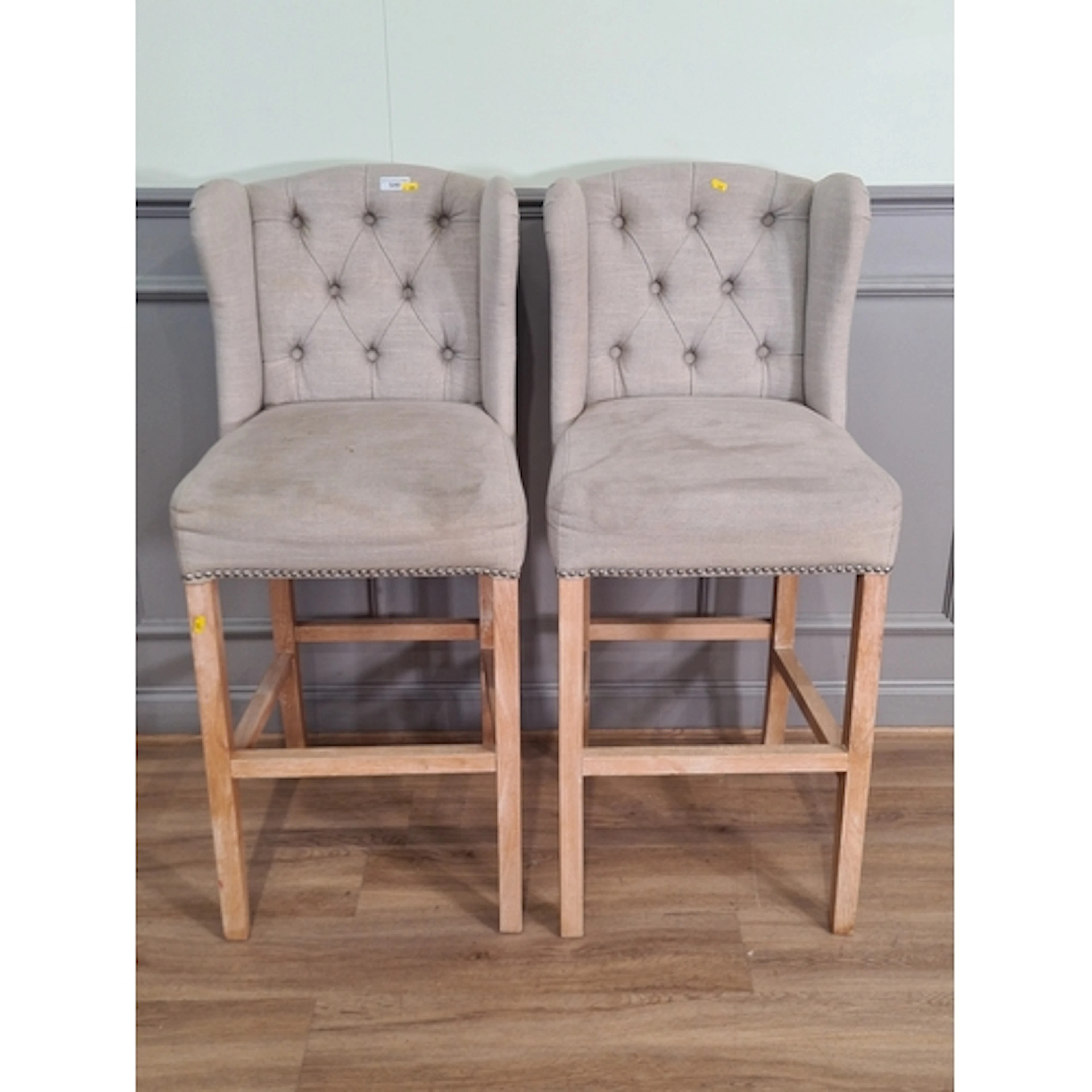 A pair of cream upholstered breakfast bar Stools, (R6).
