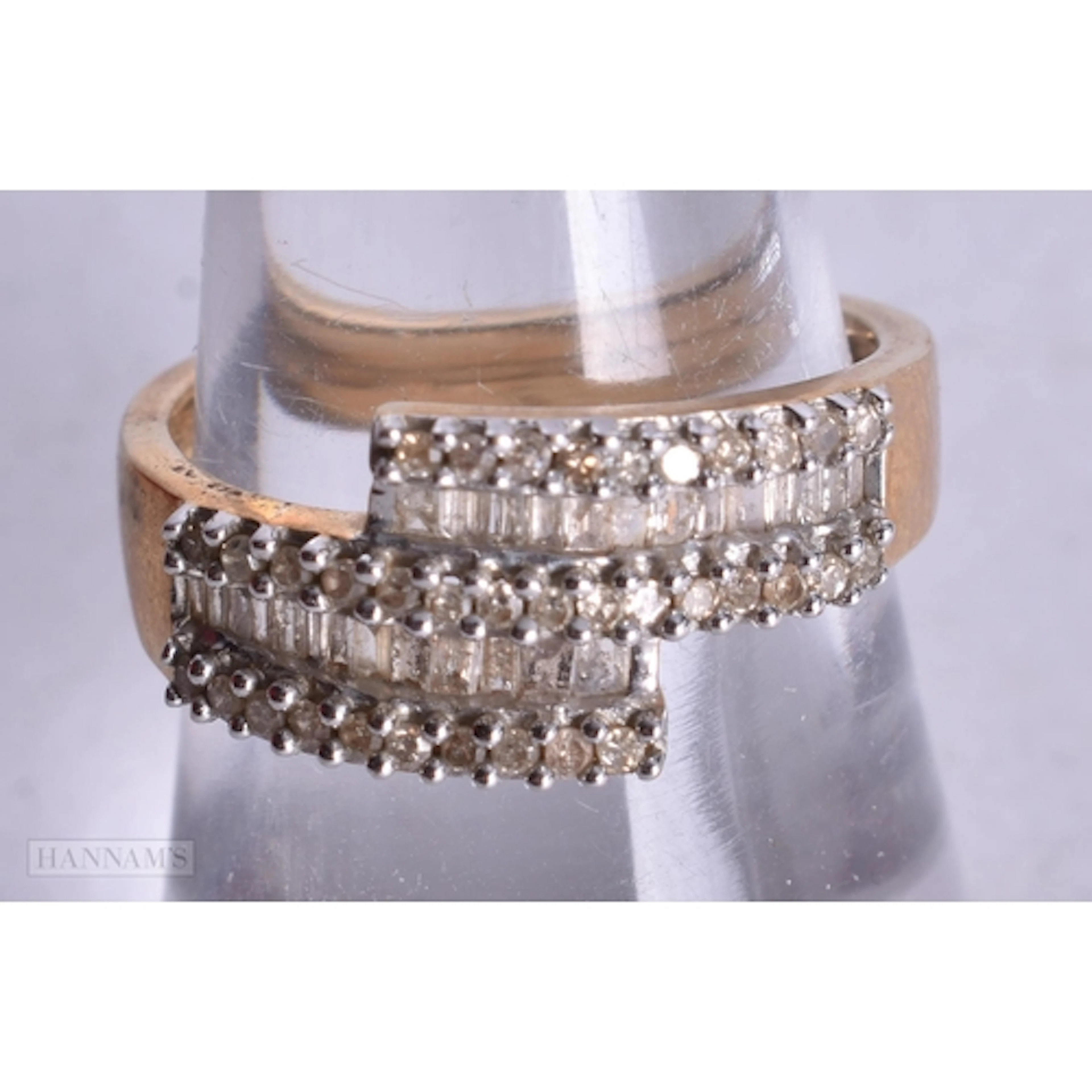 9ct gold diamond baguette and round cut bypass ring (3.4g). ...