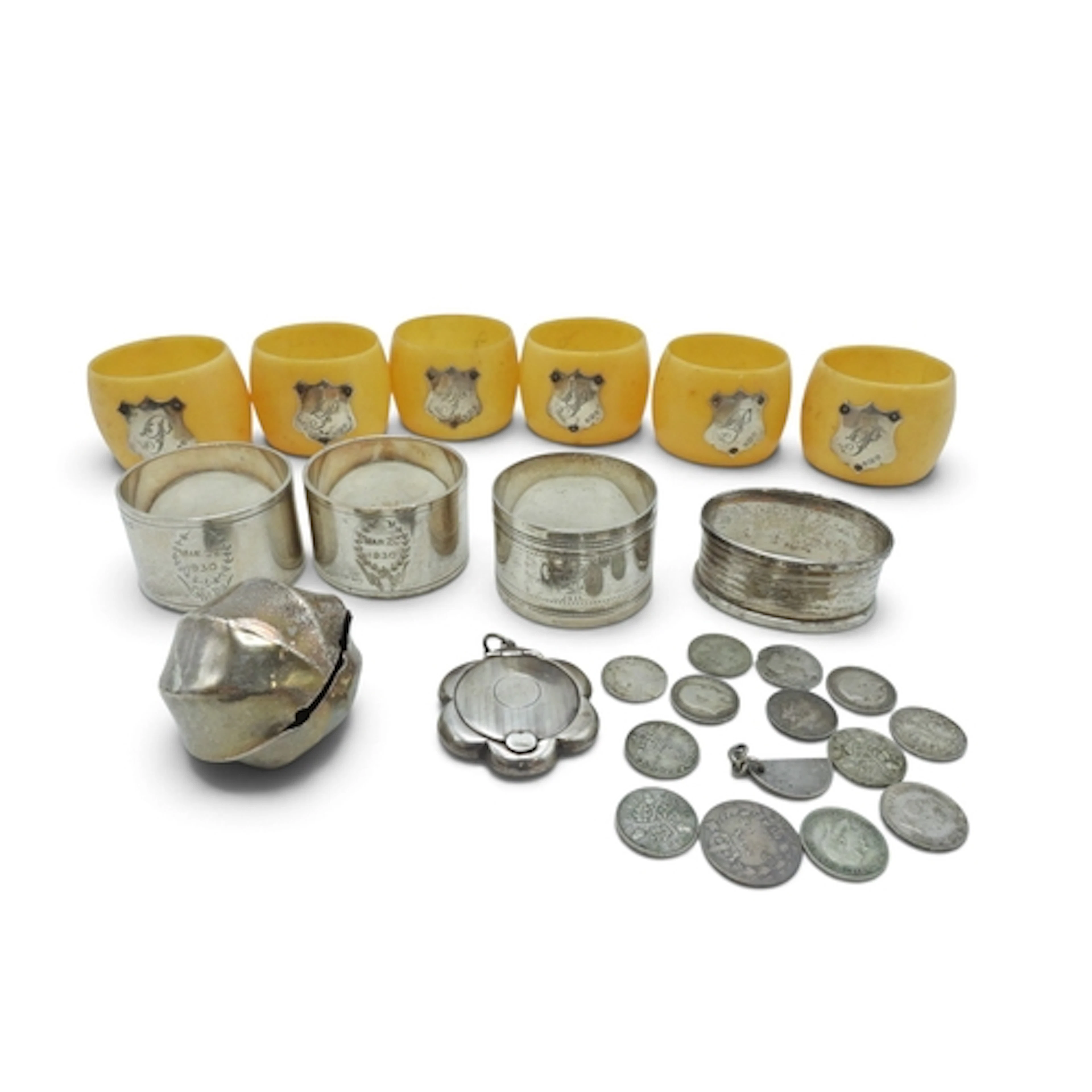 Four silver napkin rings, a pendant powder compact and white...