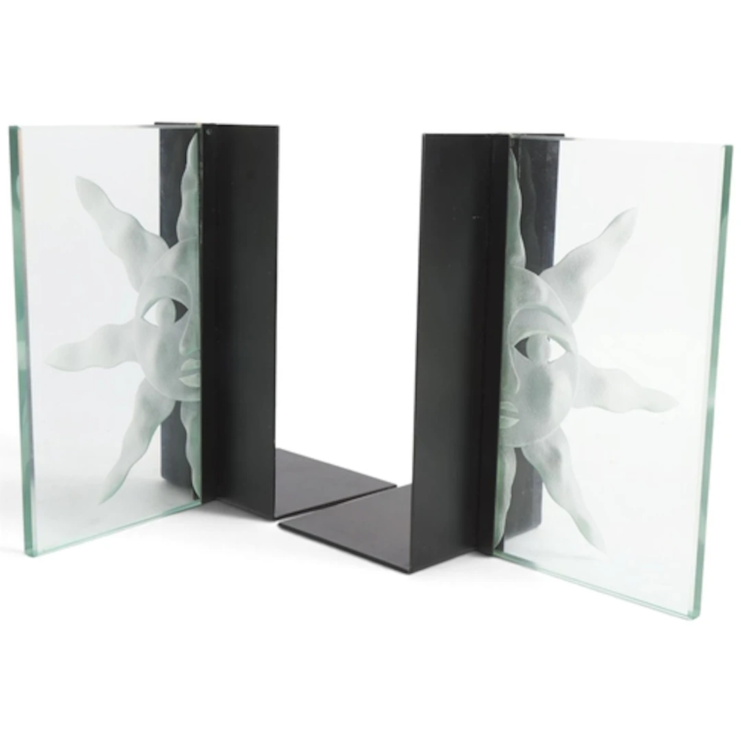 A pair of bookends with frosted glass Sun panel on black ste...