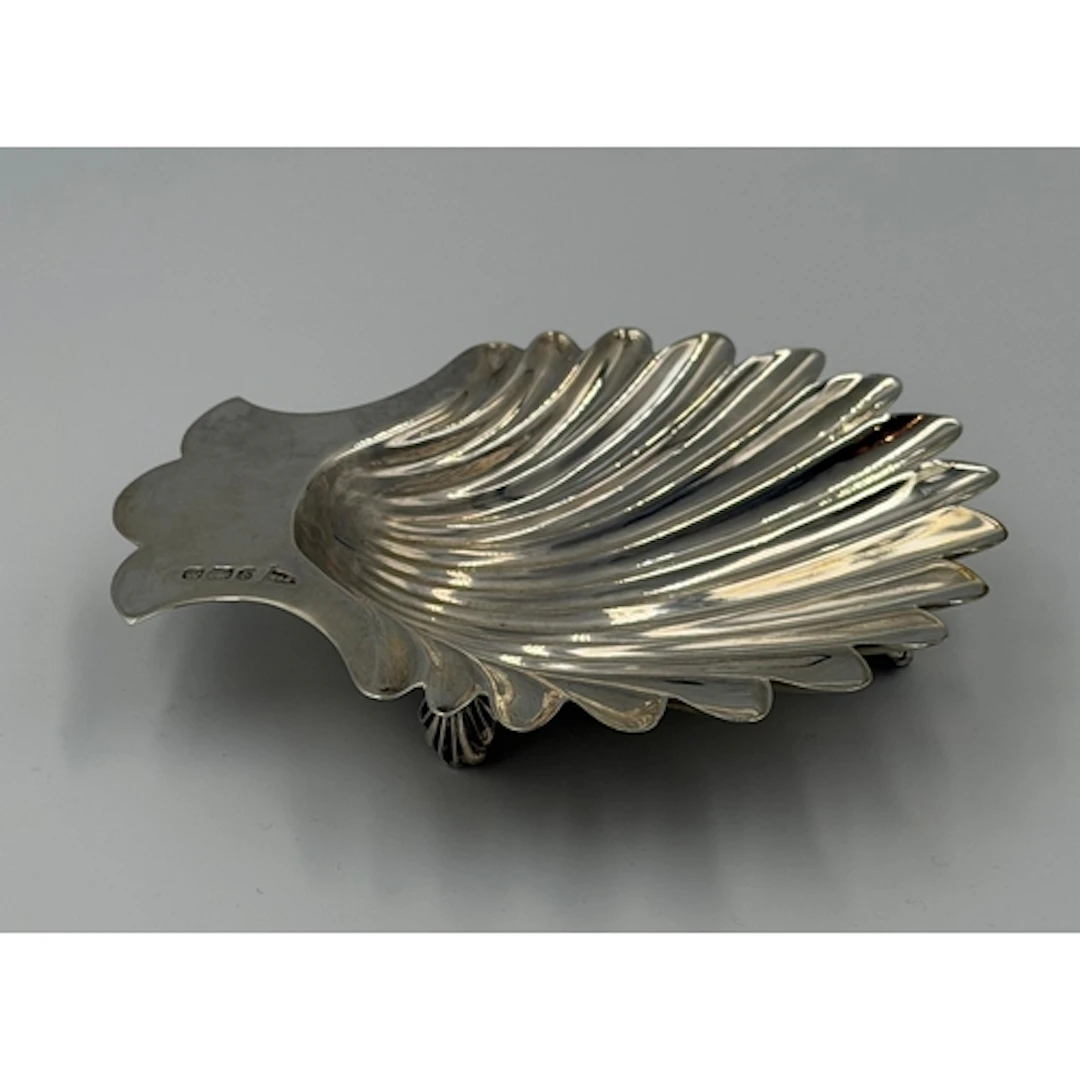 A Walker and Hall silver shell shaped dish on shell feet, ap...