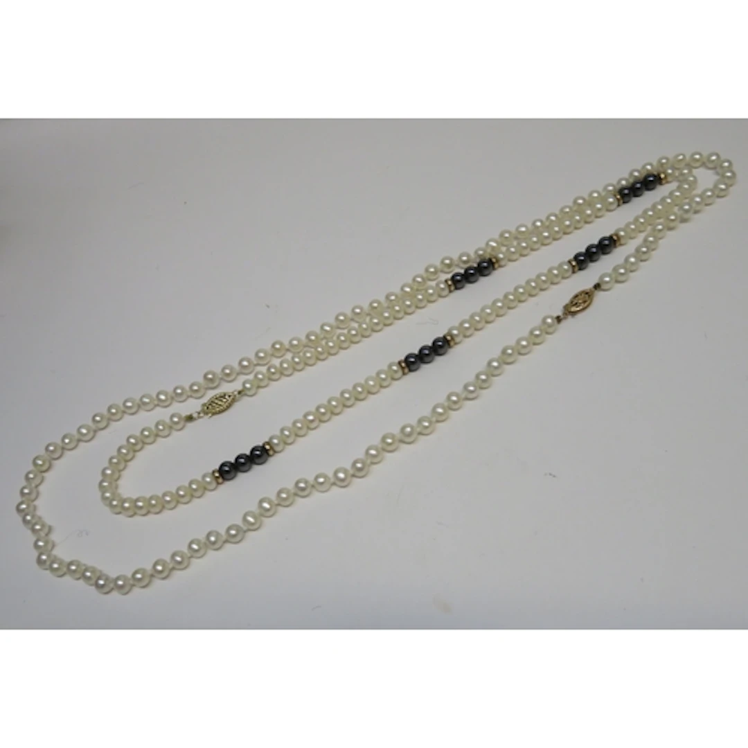 Pair of cultured pearl necklaces, one with 9ct gold clasp, t...