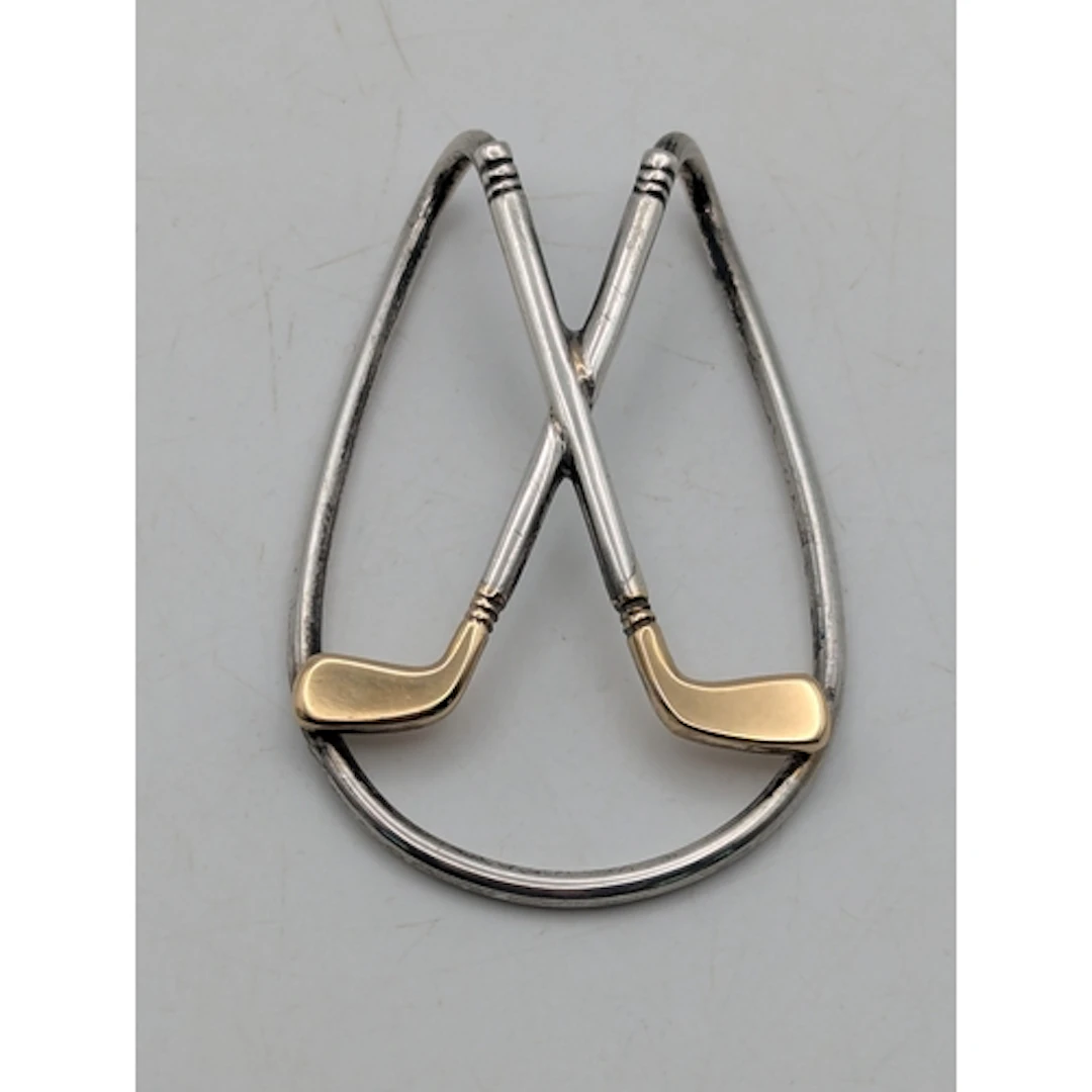 A sterling silver and 18ct yellow gold money clip featuring ...