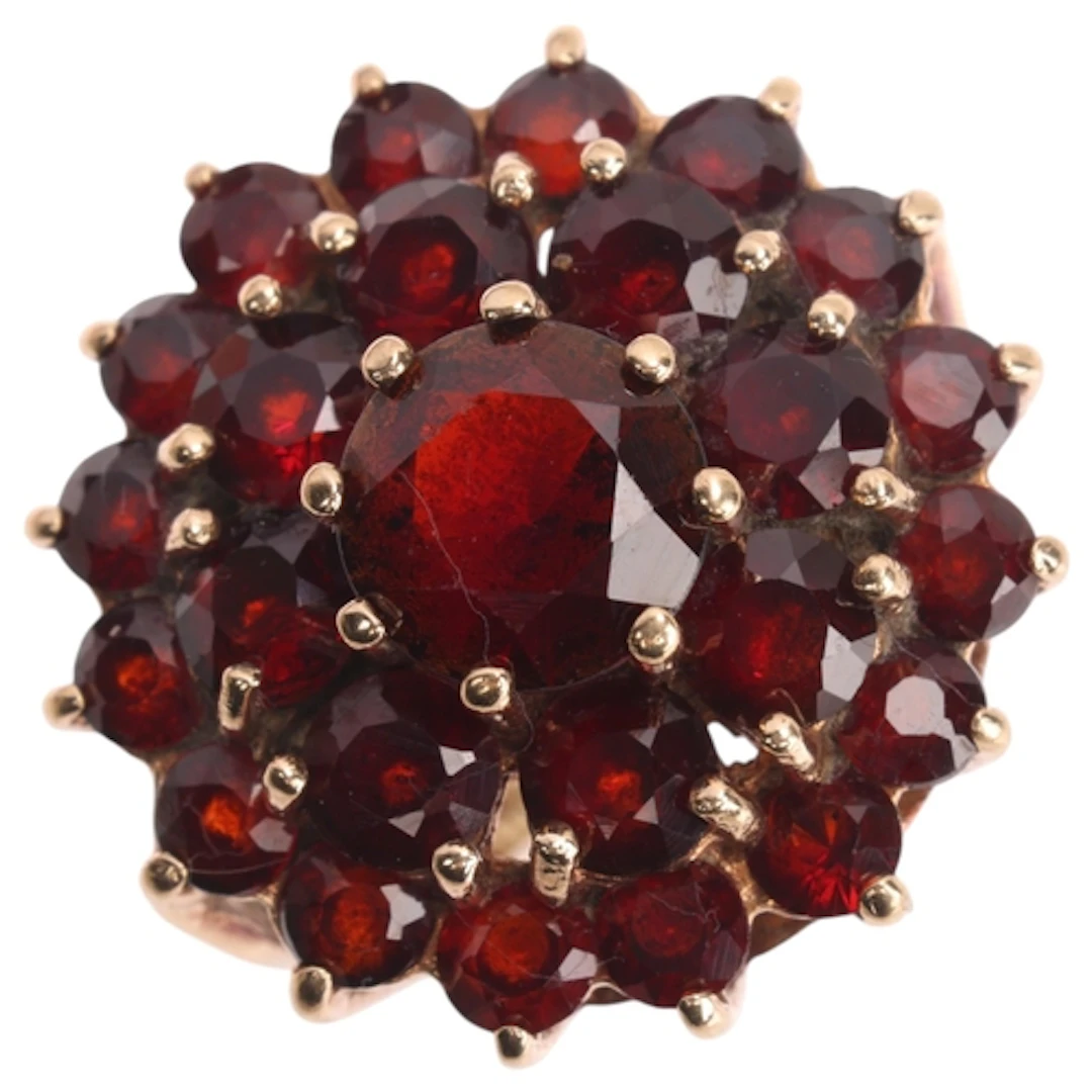 A 9ct gold garnet cluster ring, maker W & G, London 1973, se...