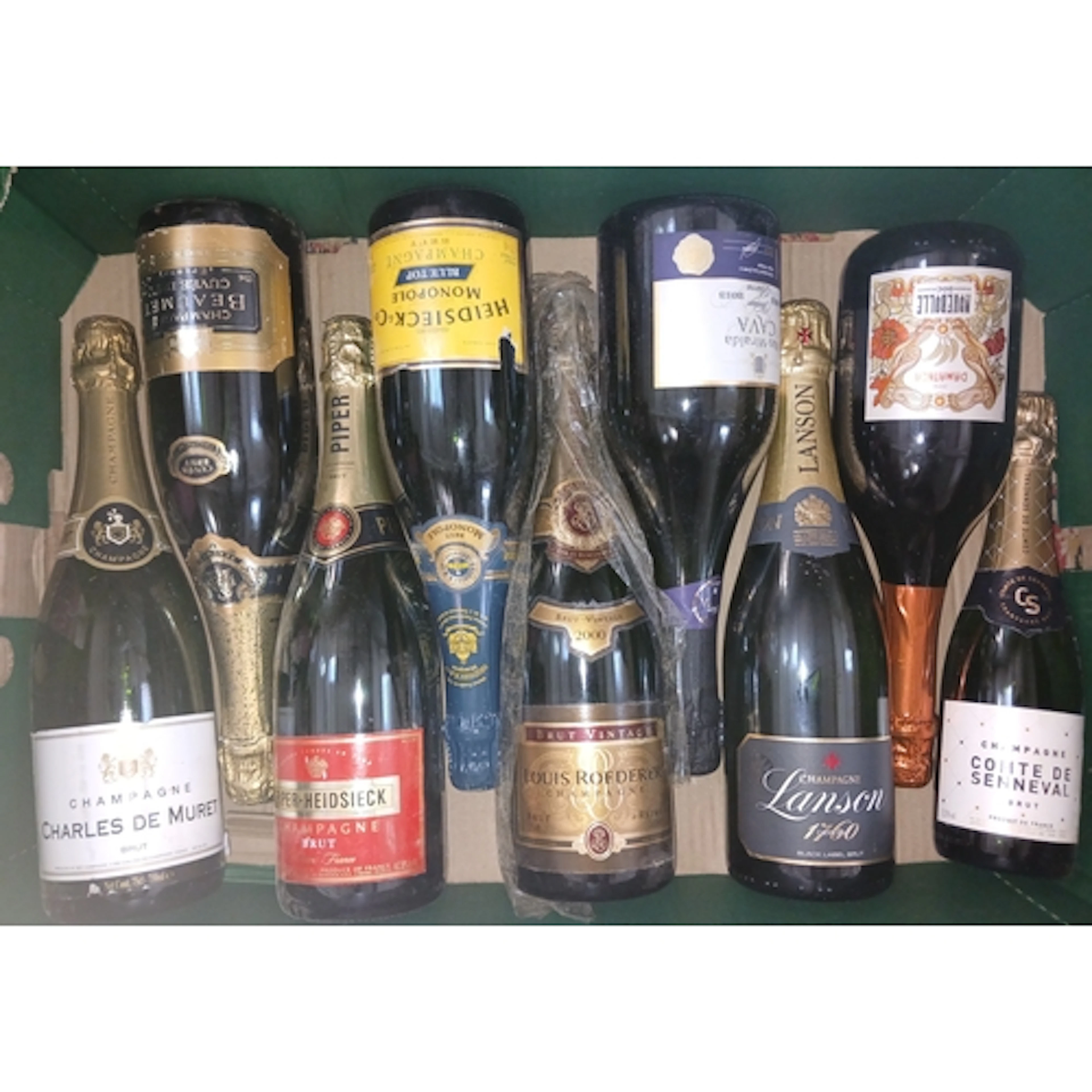 Nine bottles of assorted sparkling wine.