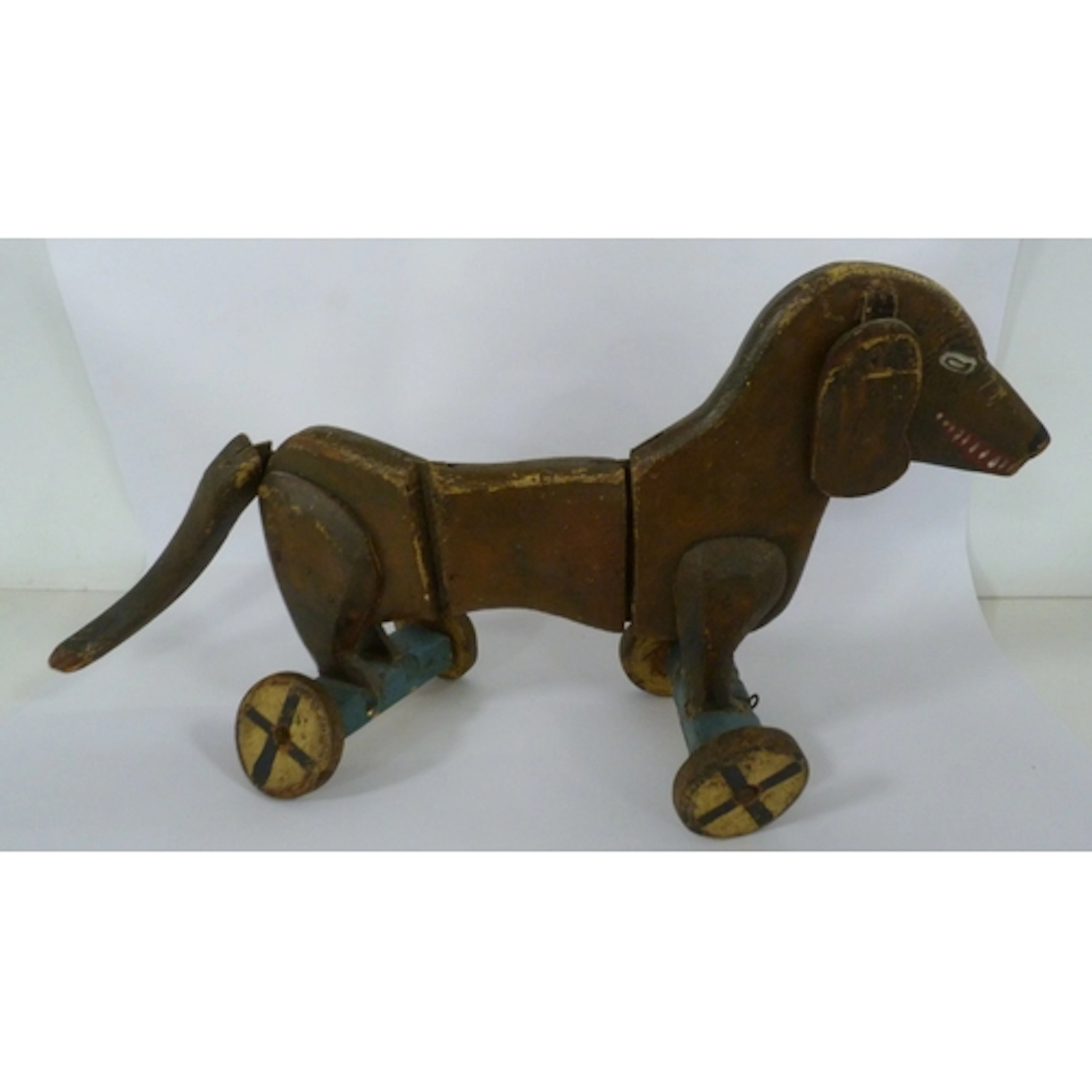 Antique articulated pull along toy in the form of a Dachshun...