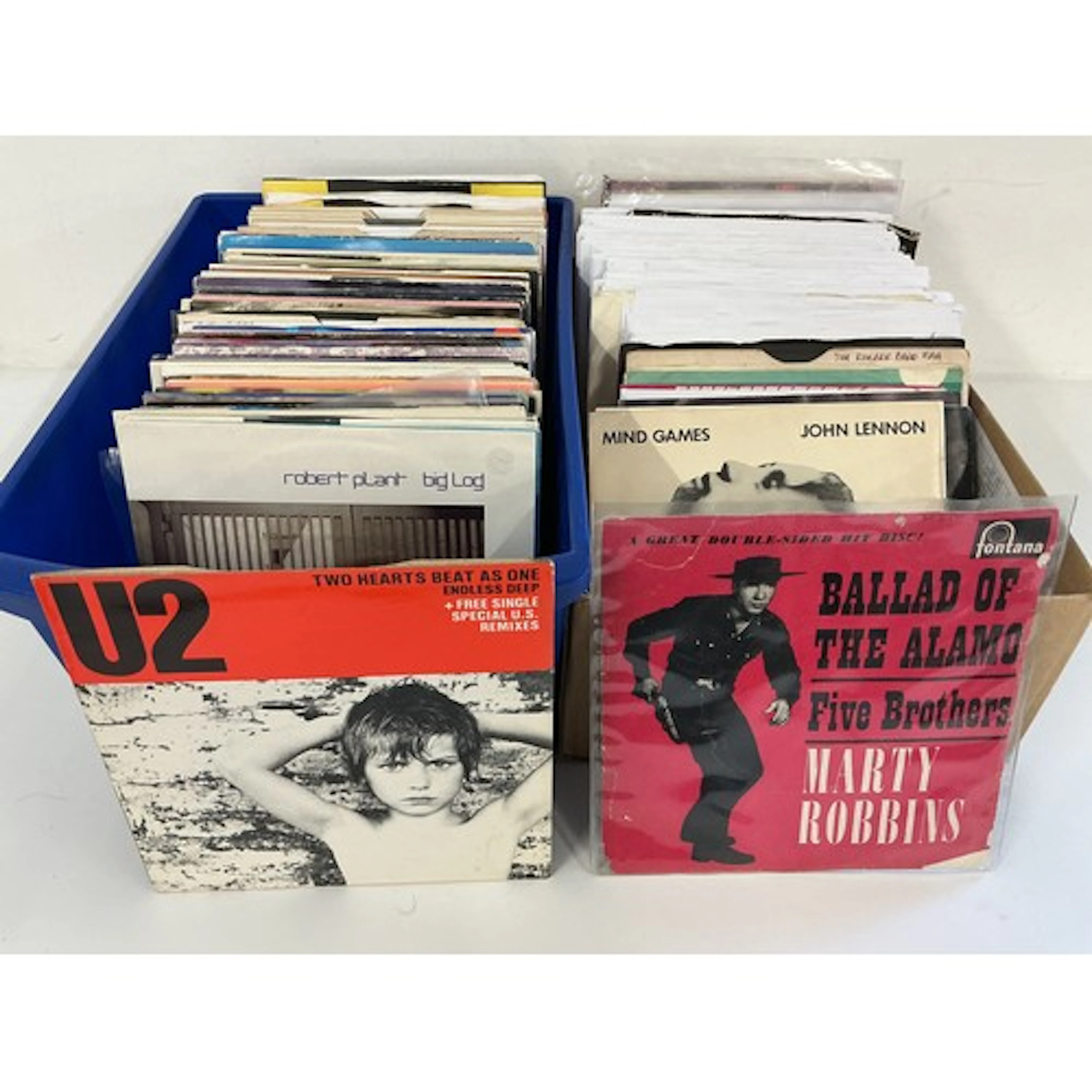 Two small boxes of 7” singles by various artists from the 19...