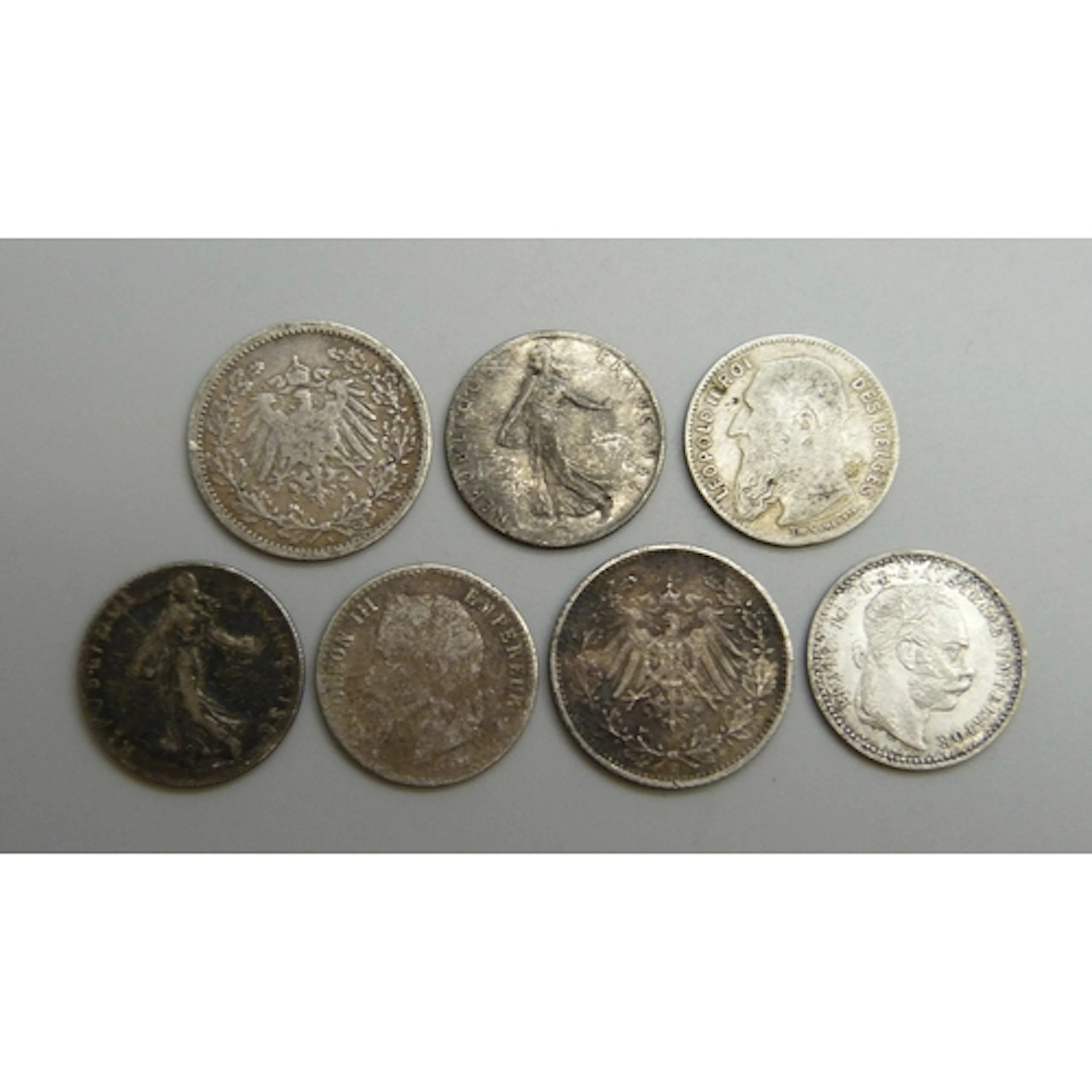A collection of world coins including Austria, France, Belgi...