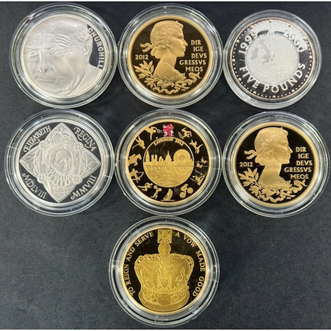 A group of seven UK silver proof £5 coins, including 1999 Mi...