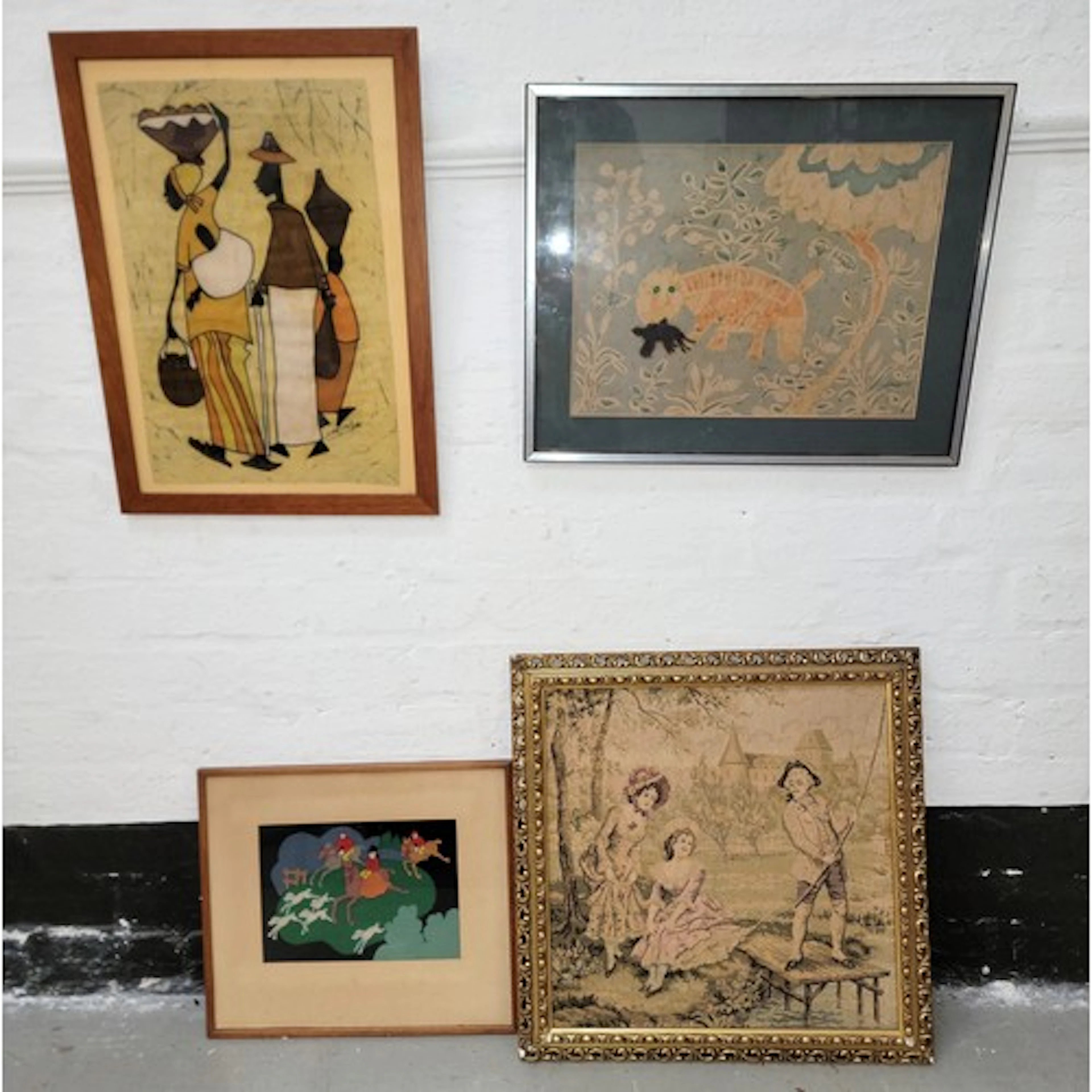 FOUR FRAMED VINTAGE TEXTILE PICTURES comprising a gilt frame...
