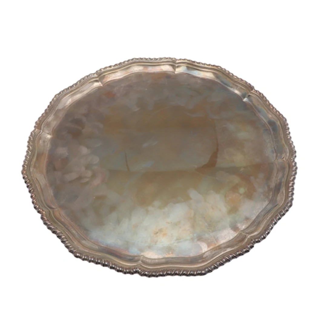A SILVER SALVER. Of shaped circular form with gadrooned rim,...