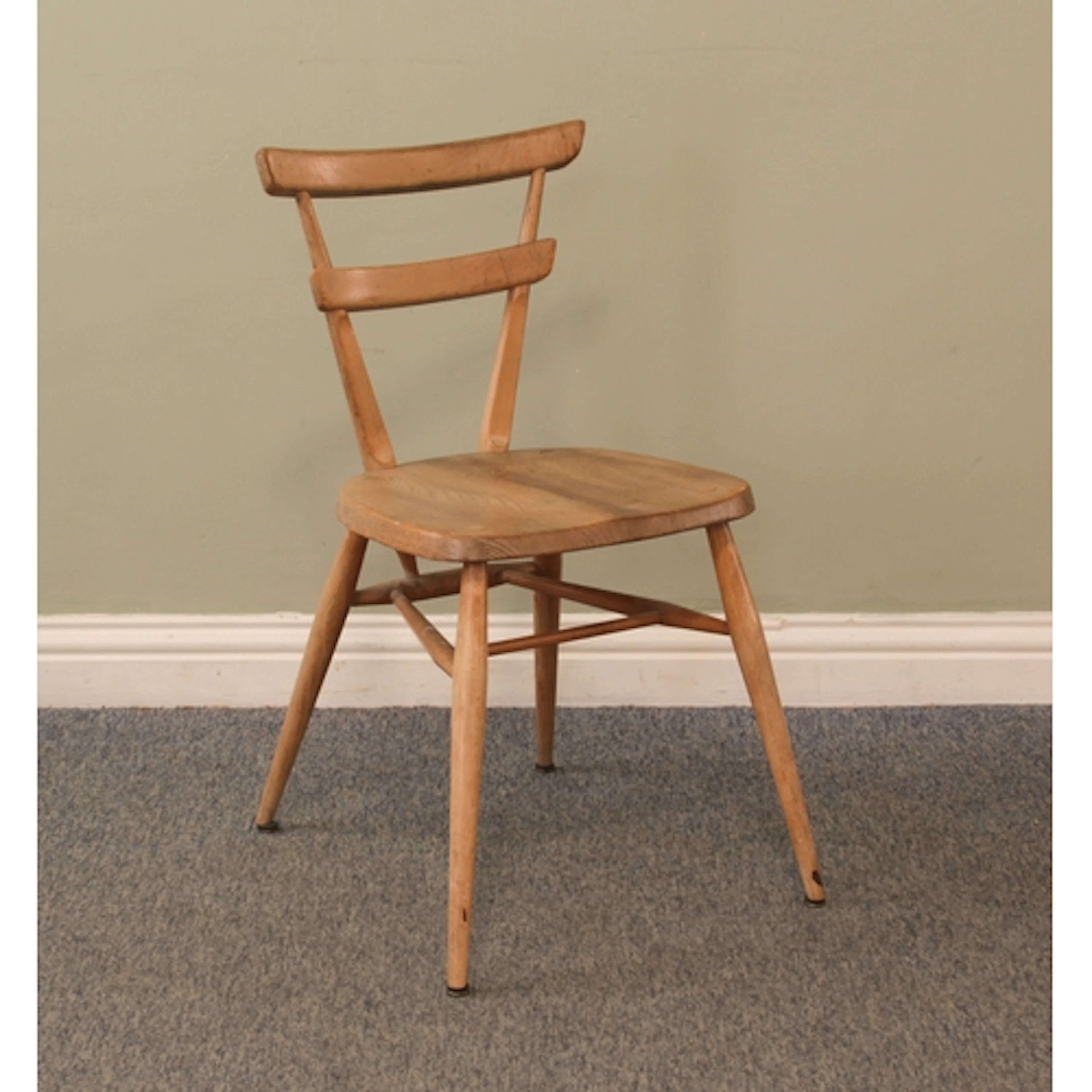 A vintage Ercol 'green dot' beech and elm stacking school ch...